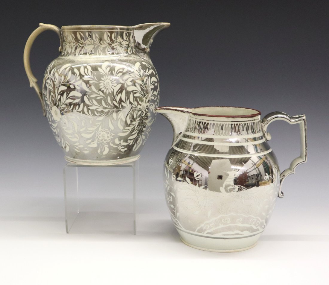 2 Silver Lustre Jugs: Two 19th century English Pearlware jugs with Silver lustre decoration. One with flowers and foliage the second with Parrots in foliage. Wear, crazing, light surface scratches, shallow edge flakes, 1/2