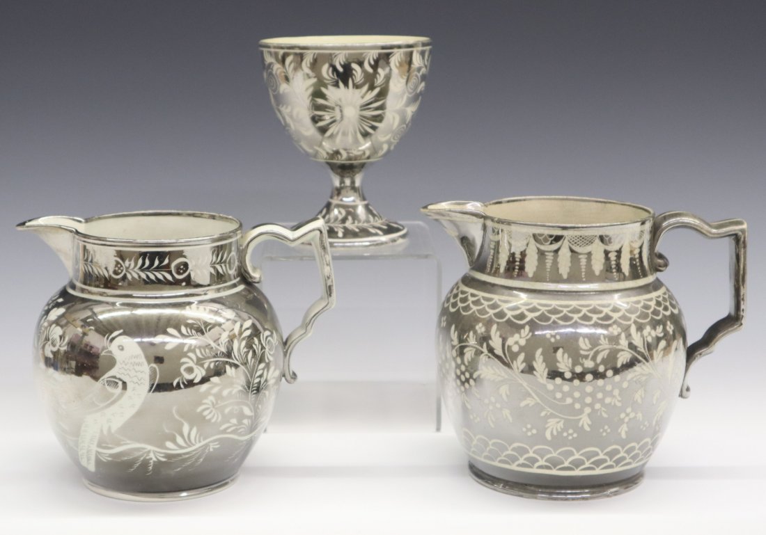 3 Silver Lustre Items: Three 19th century English Pearlware items with Silver lustre decoration, one footed cup and two jugs. All with flowers and foliage, one jug with Parrots. Wear, crazing, light surface scratches, minor