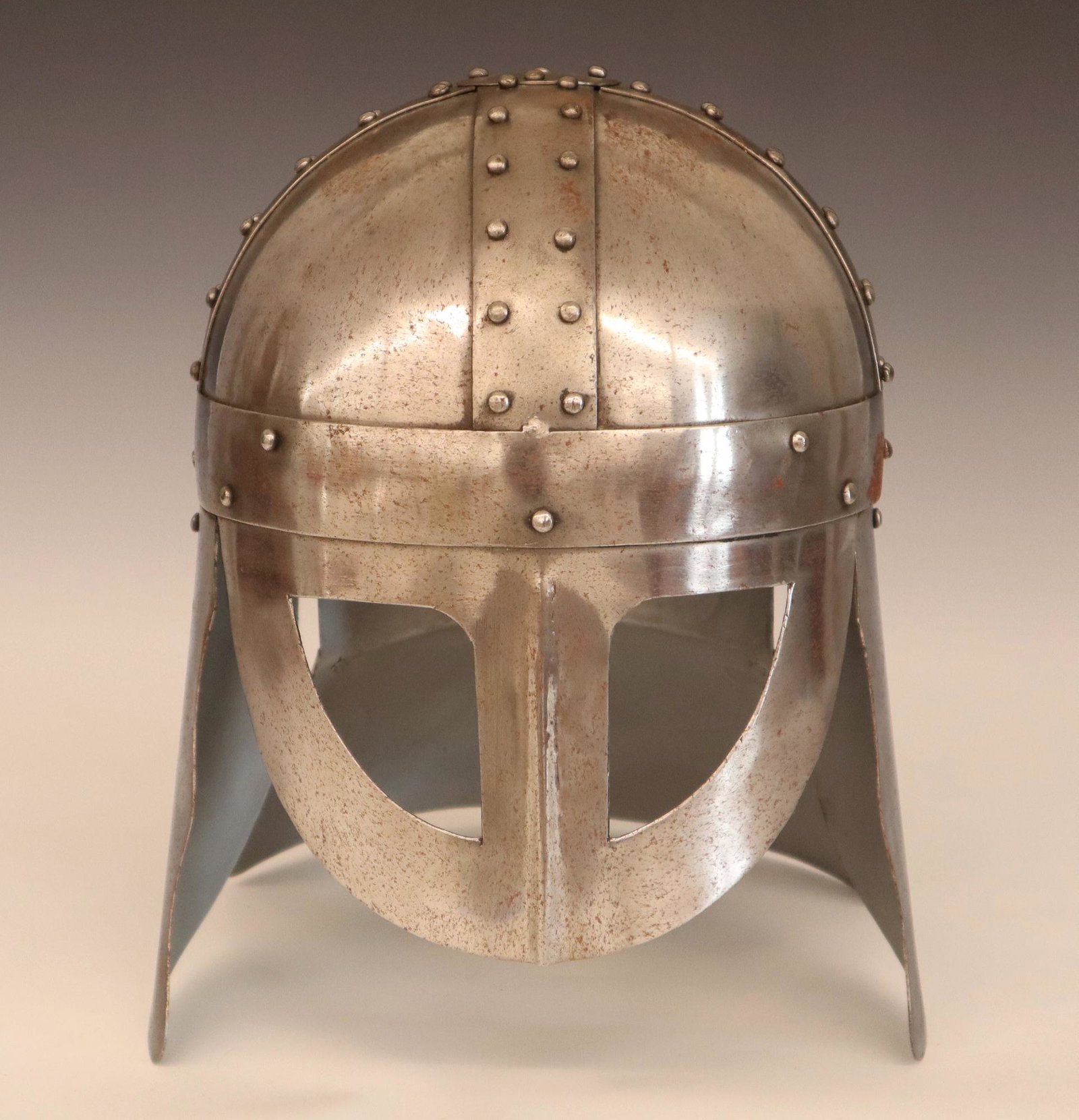 Replica Knight's Helmet: A good quality replica Knight's helmet. Steel with riveted joints and hinged ear pieces. Minor surface corrosion. 12" high. ESTIMATE $100-150