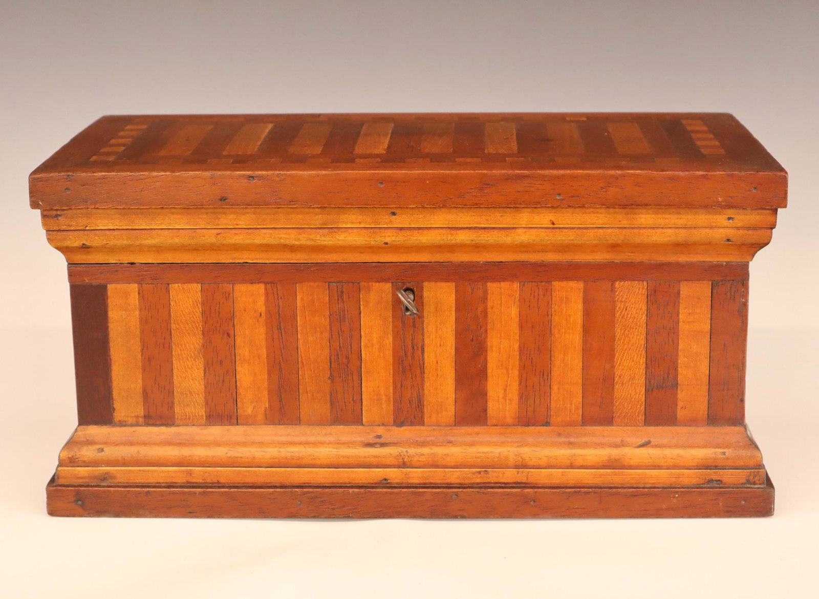 Folk Art Box: A late 19th century American Folk Art box. Alternating strips of Walnut and Maple on a softwood frame. Old finish with minor wear. 14 3/4 x 7 3/4 x 7 1/4" high. ESTIMATE $200-300