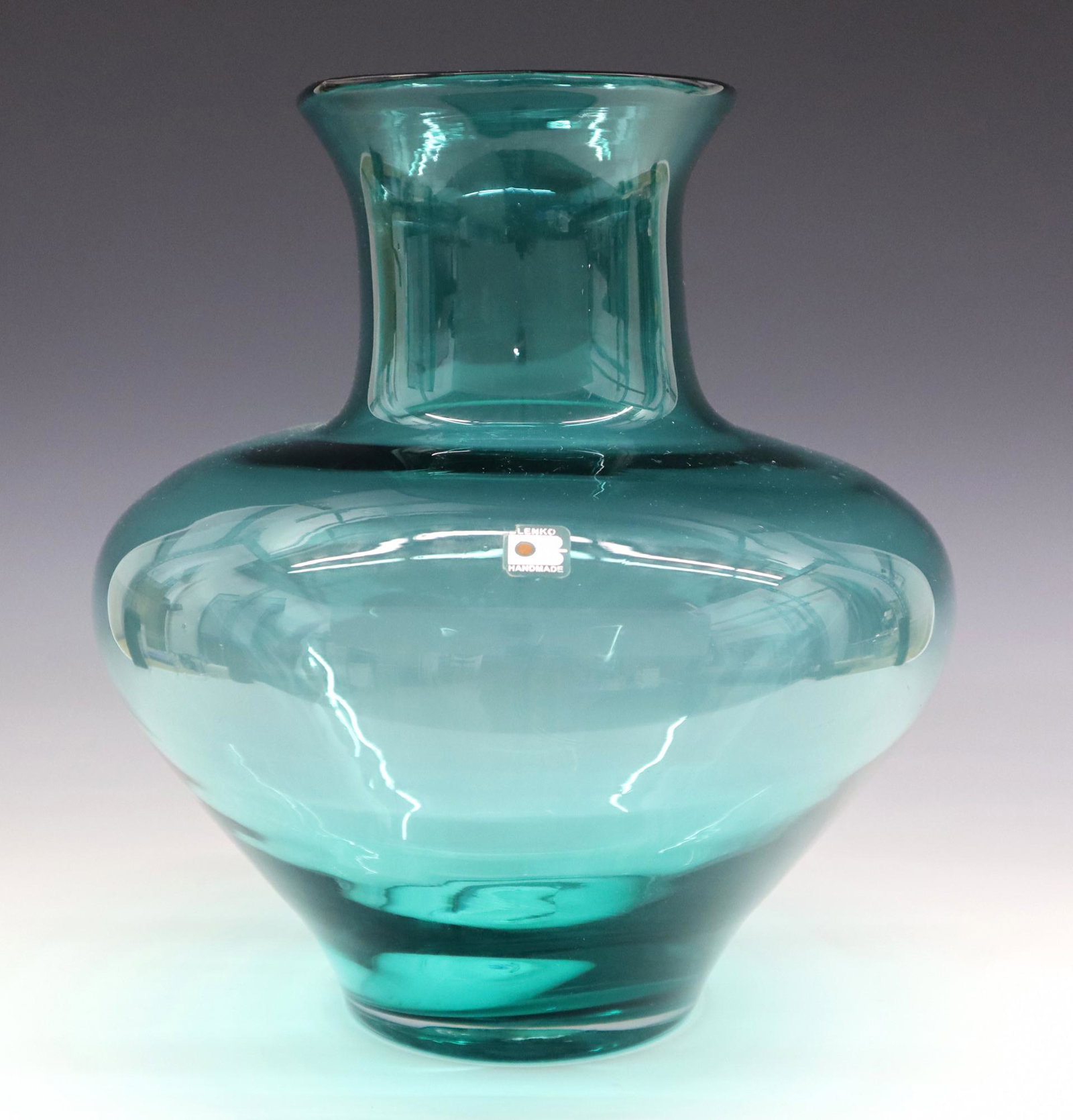 Blenko Vase: A late 20th century Blenko vase. Bulbous design in Blue/Green glass. Retains original label. Minor wear. 12 1/2" high. ESTIMATE $50-75