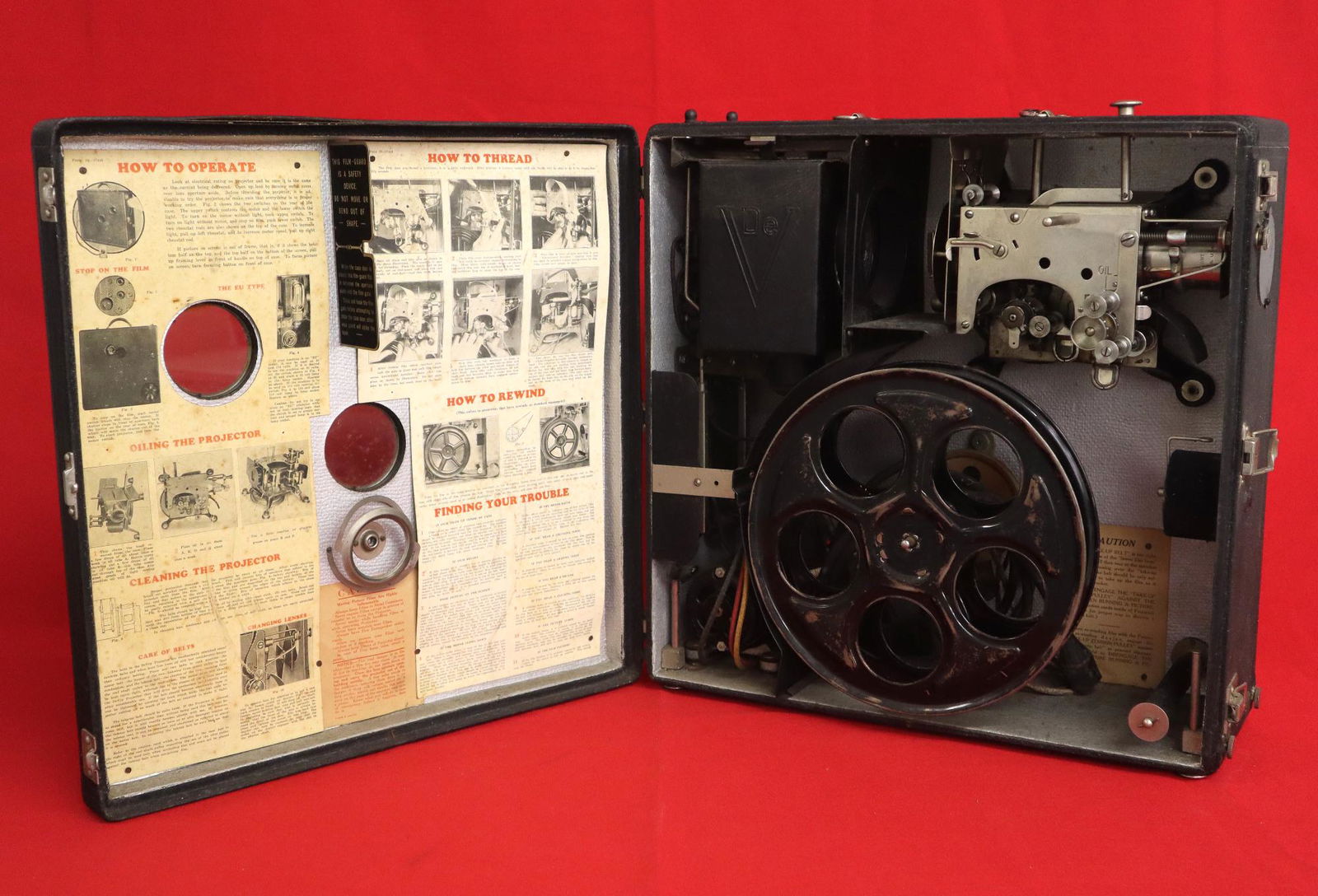 DeVry Movie Projector: A vintage DeVry "Portable Motion Picture Projector". Type E, Model 17265. Operating instructions inside cover. Some wear, minor damage to case. 17 1/2 x 7 1/4 x 17 1/2" overall. ESTIMATE $200-300