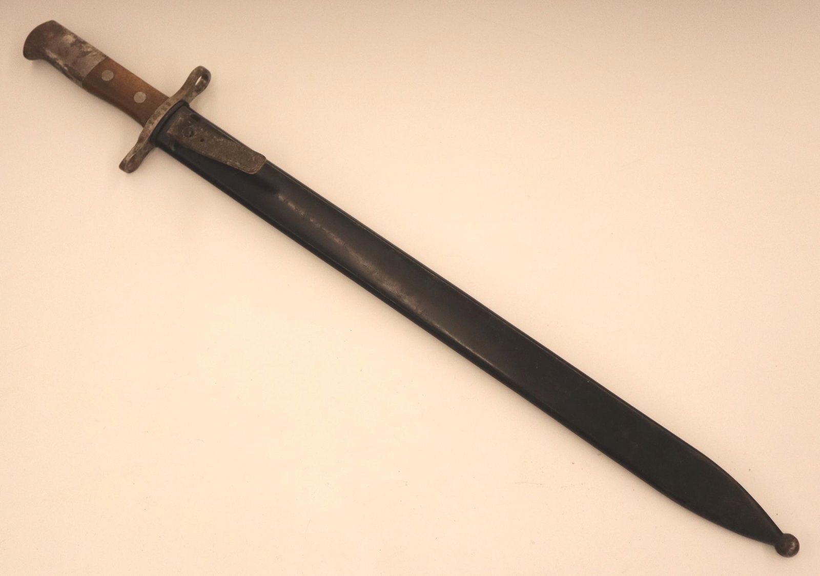 WWI Swiss Bayonet: A WWI Era Swiss saw-back bayonet. Marked with a Swiss Cross and "HS", serial #62403. With the original metal scabbard. Some wear and minor corrosion. 24" long. ESTIMATE $200-300