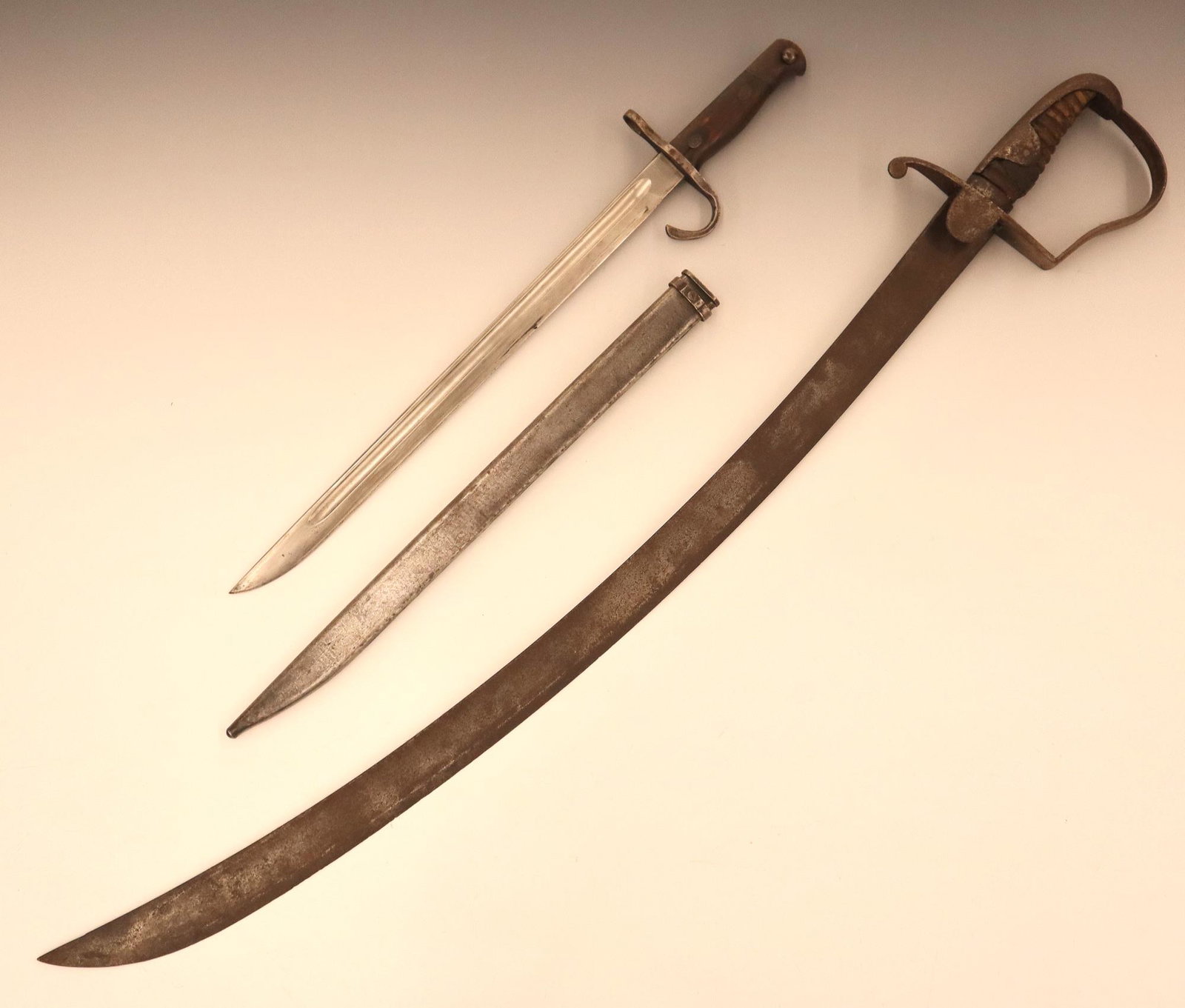 Japanese Sword and Bayonet: An early 20th century Japanese sword and a WWII Era bayonet (bayonet marked "Hoten Zoheisho Arsenal"). Both with wear, heavy rust on the sword. 34" and 20 1/2" long. ESTIMATE $100-200