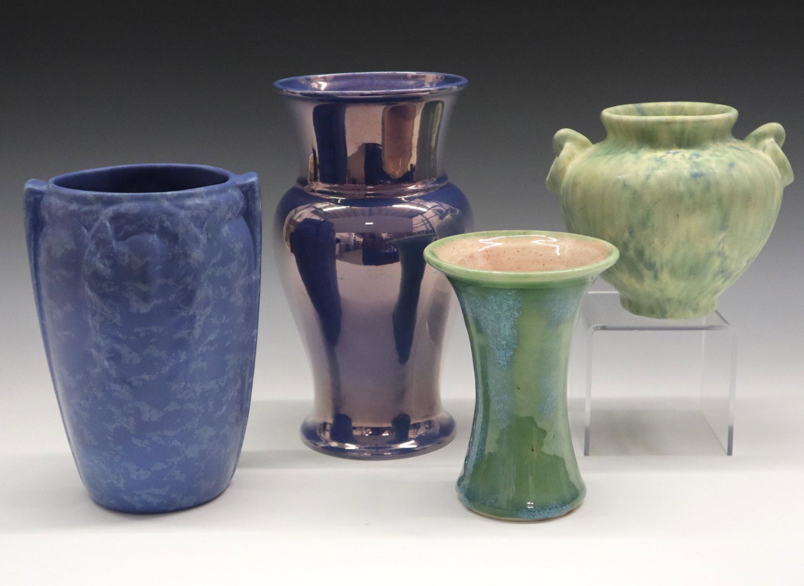 4 Art Pottery Vases: Four 20th century Art Pottery vases. Includes a Green Camark vase, a Blue/Green Pisqah Forest vase, a Blue Rum-Rill vase and a Blue iridescent Cowan vase. Various marks. Slight wear. 4 1/2" to 8 1/4"