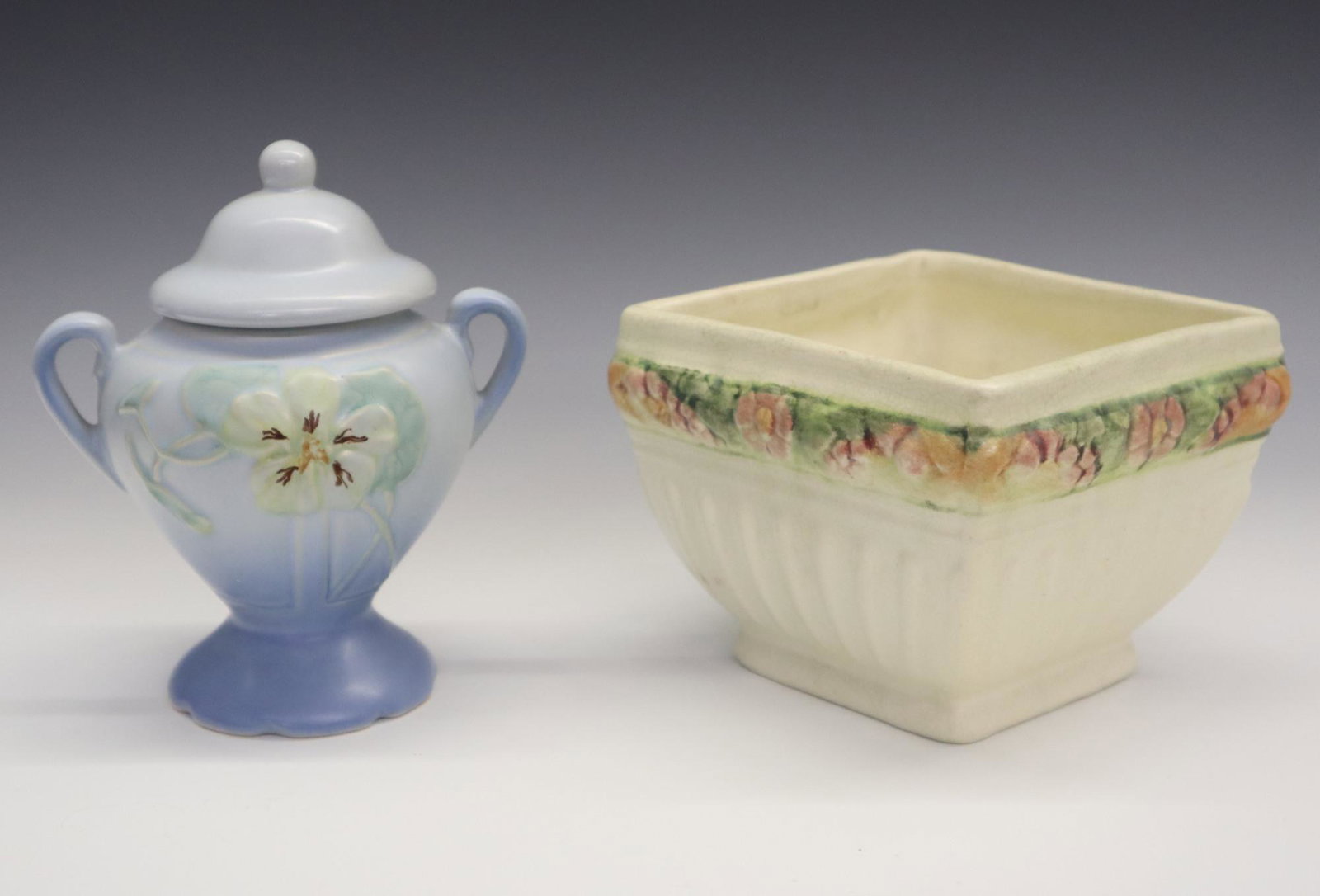2 Weller Art Pottery Pieces: Two 20th century Weller Art Pottery pieces. Includes a "Panella" covered vase and a square "Roma" footed bowl. Molded and impressed marks. Minor wear. 6 1/2 and 4 3/4" high. ESTIMATE $50-75