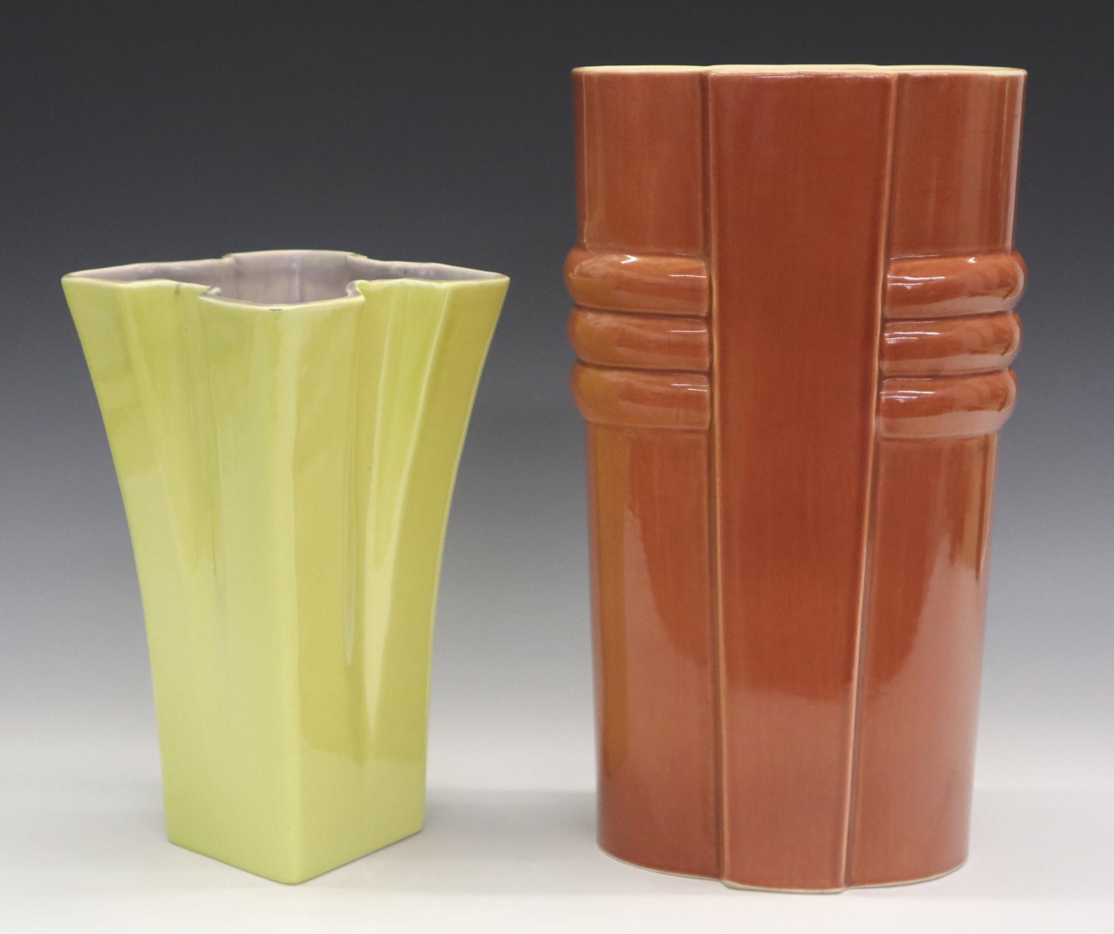 2 pc Red Wing Vases: Two 20th century Red Wing vases. Mid Mod designs in Coral and Yellow, one with partial foil label. Molded marks. Minor surface wear. 9" and 12" high. ESTIMATE $50-75