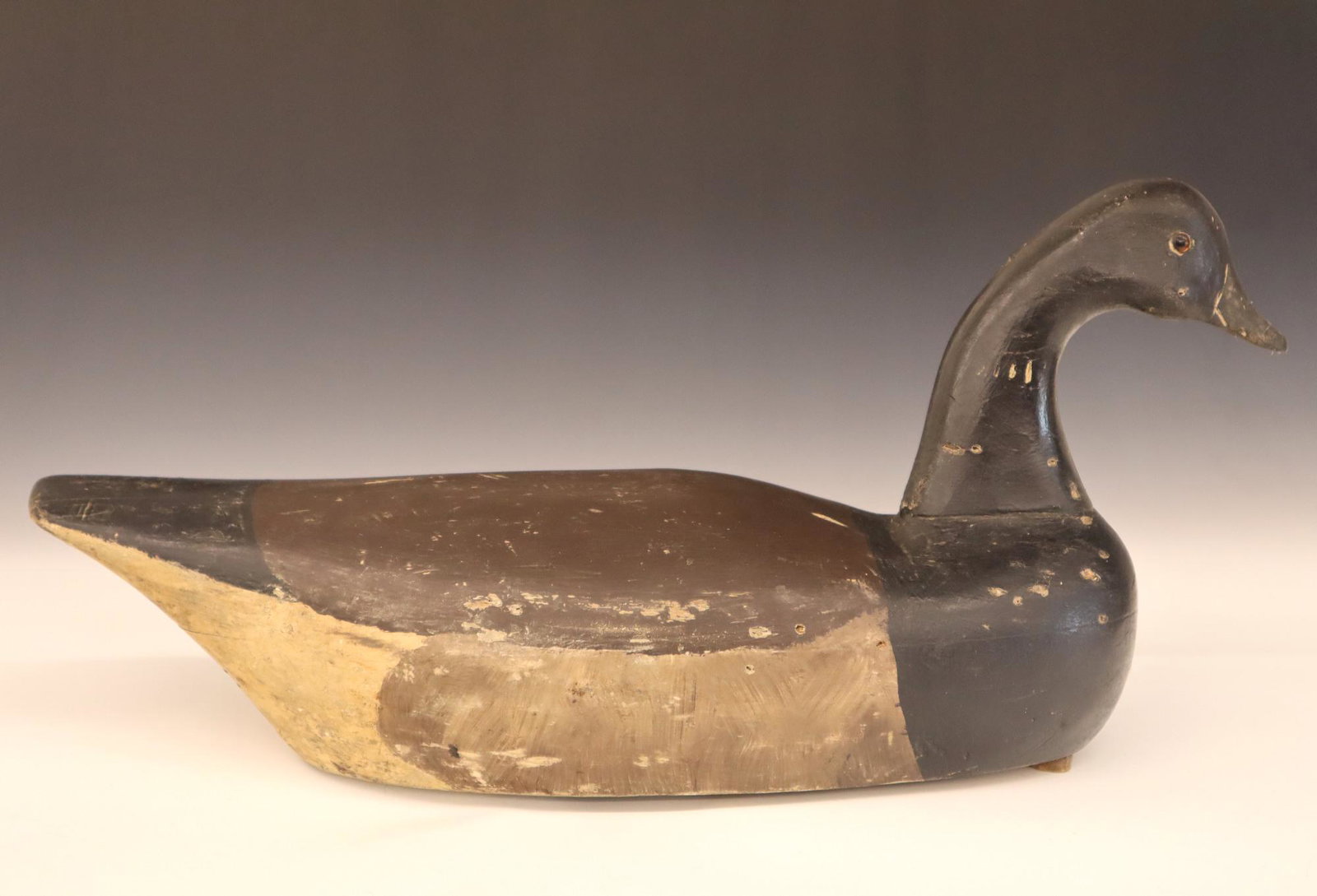 Charles Wilber Brant Goose Decoy: A 1940's Charles Wilber (New Jersey) Brant Goose Decoy, stamped "century.". Carved wooden body with glass eyes and original paint. Minor wear overall. 19" long. ESTIMATE $200-300