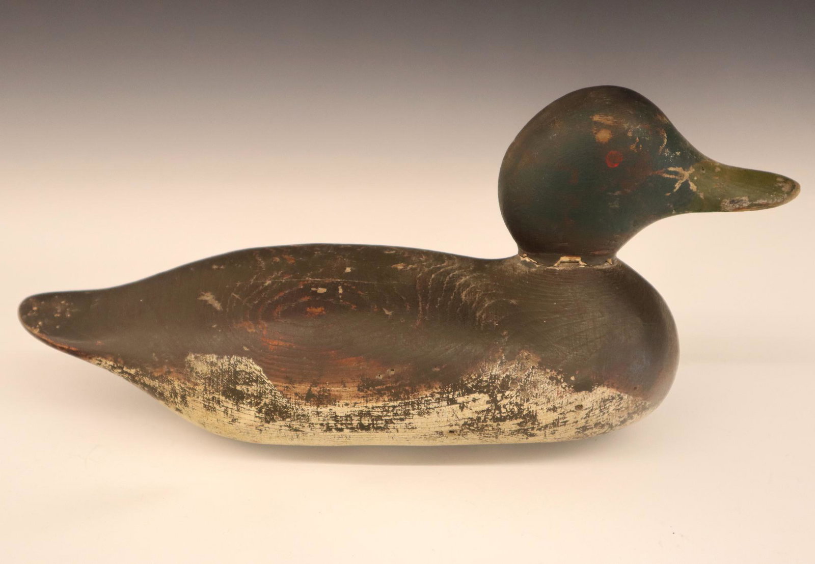 Mason Factory Black Drake Duck Decoy: A 1950's Mason Factory Standard Grade Black Drake Duck Decoy. Carved wooden body with painted eyes and old paint. Filler loss at neck and wear to paint. 13 1/2" long. ESTIMATE $100-200