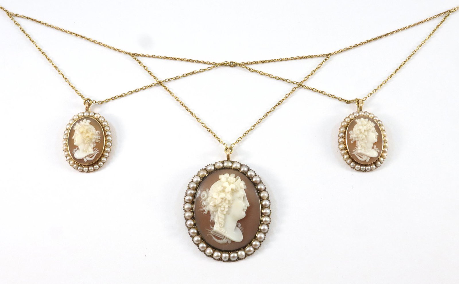 14k Gold Necklace with Cameos: A 14k Gold necklace with three carved shell cameos with seed Pearls. 16.8 grams total weight. Slight wear. Approx. 14" long. ESTIMATE $400-600