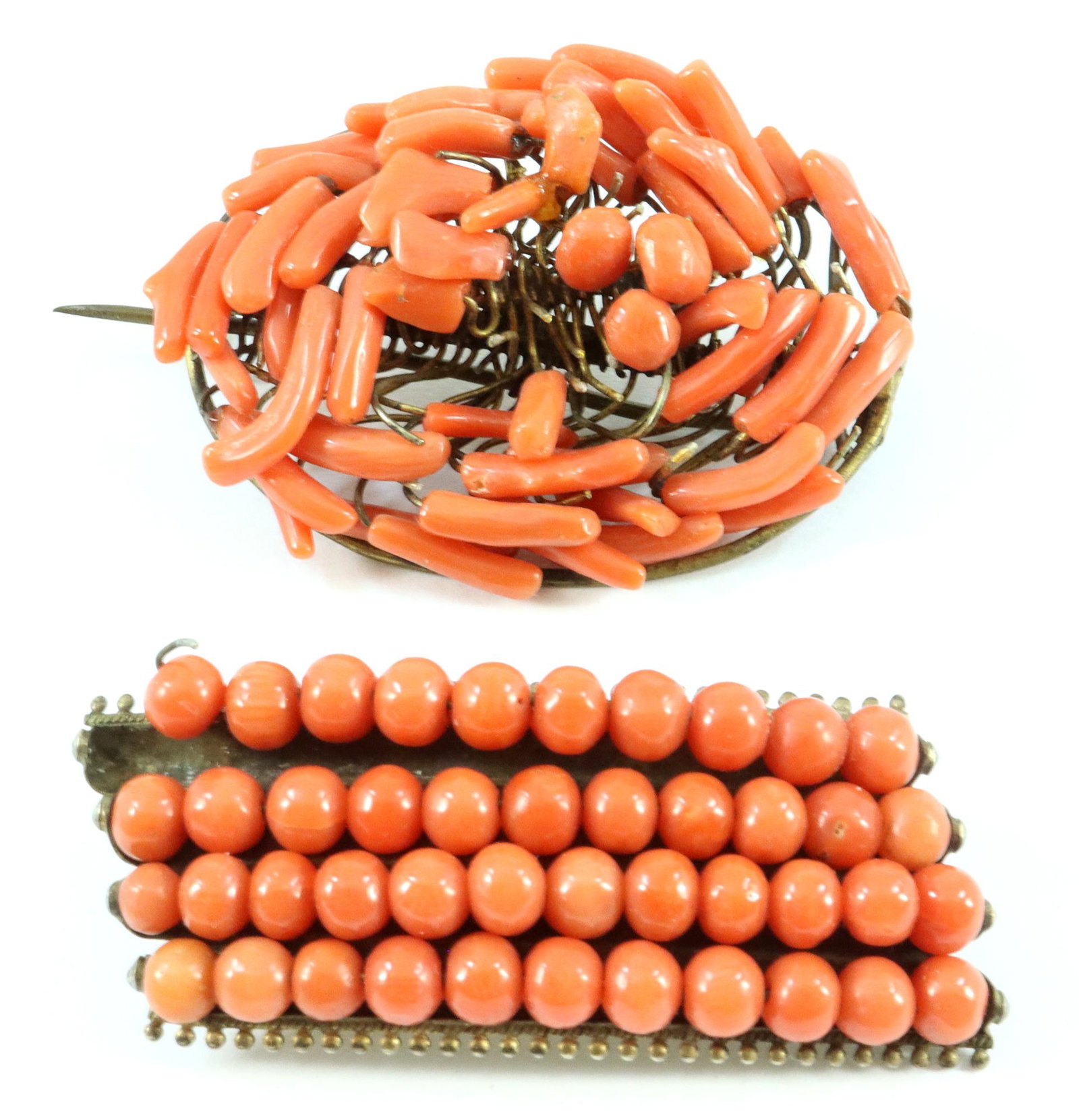 2 Coral Brooches: Two Coral Brooches. One set in .800 Silver. 20.0 grams total weight. Both with damage and missing beads. ESTIMATE $40-60