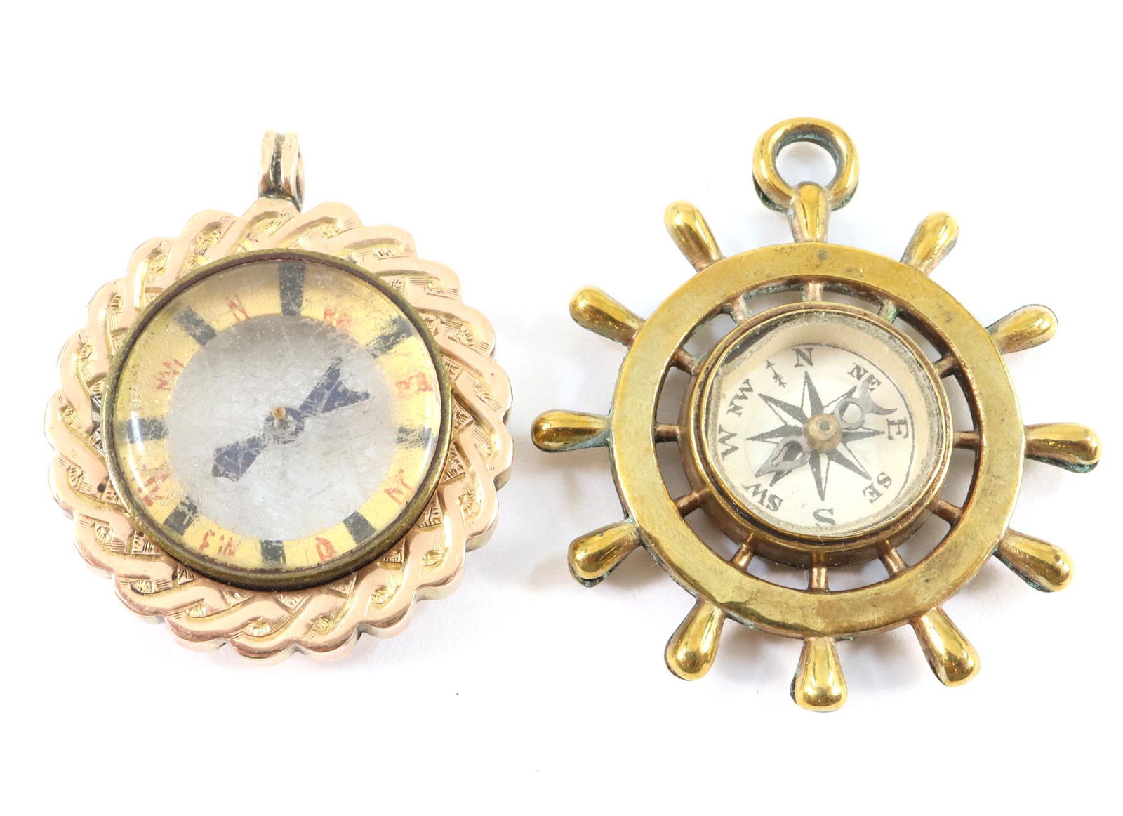 2 Compass Pendants: Two 20th century compass pendants in Gold plated settings. Some wear. Up to 1 3/8" diameter. ESTIMATE $40-60