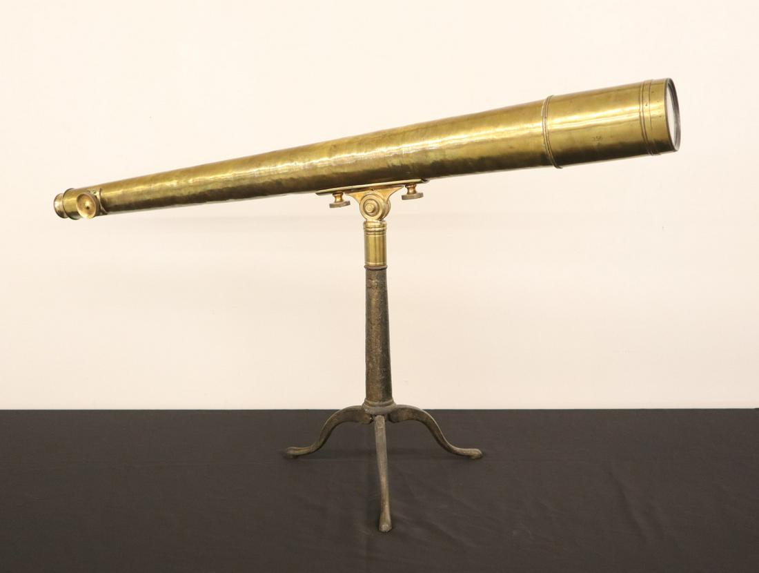 Brass Telescope: A 19th century English Brass 3 section telescope on cast Iron folding tripod, marked "T. Cooke & Sons Ltd. London & York". With focus Knob on side and swivel fitting which attaches to the tripod. Old 