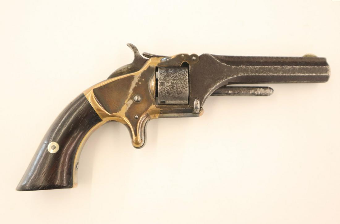 Smith and Wesson No. 1 Revolver: A Smith and Wesson No. 1 second issue .22 cal seven shot rim fire Revolver, c. 1860-1868. Serial # 106703. Significant pitting to barrel, some wear and loss to the nickel plating; minor wear to the ha