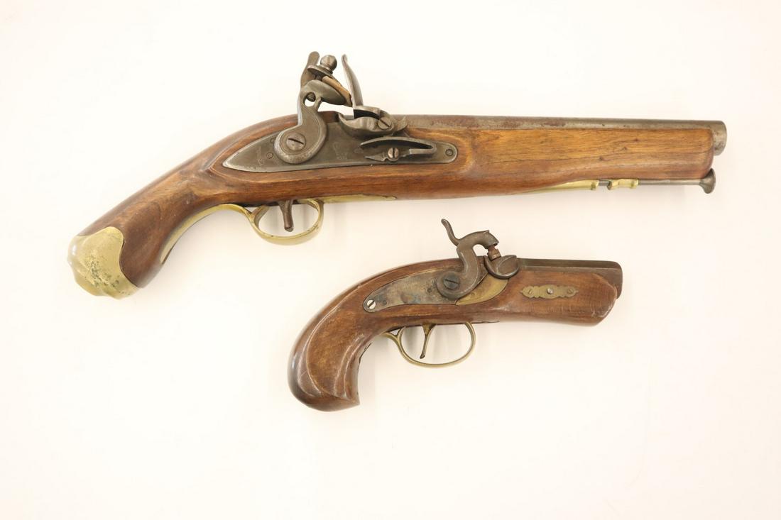 2 Replica Black Powder Pistols: Two 20th century Replica Black Powder Pistols. A .45 cal percussion pistol, marked "Derringer, Philadelphia" on lock plate and "Spain" on barrel; as well as a .65 cal flint lock pistol marked "Tower" 