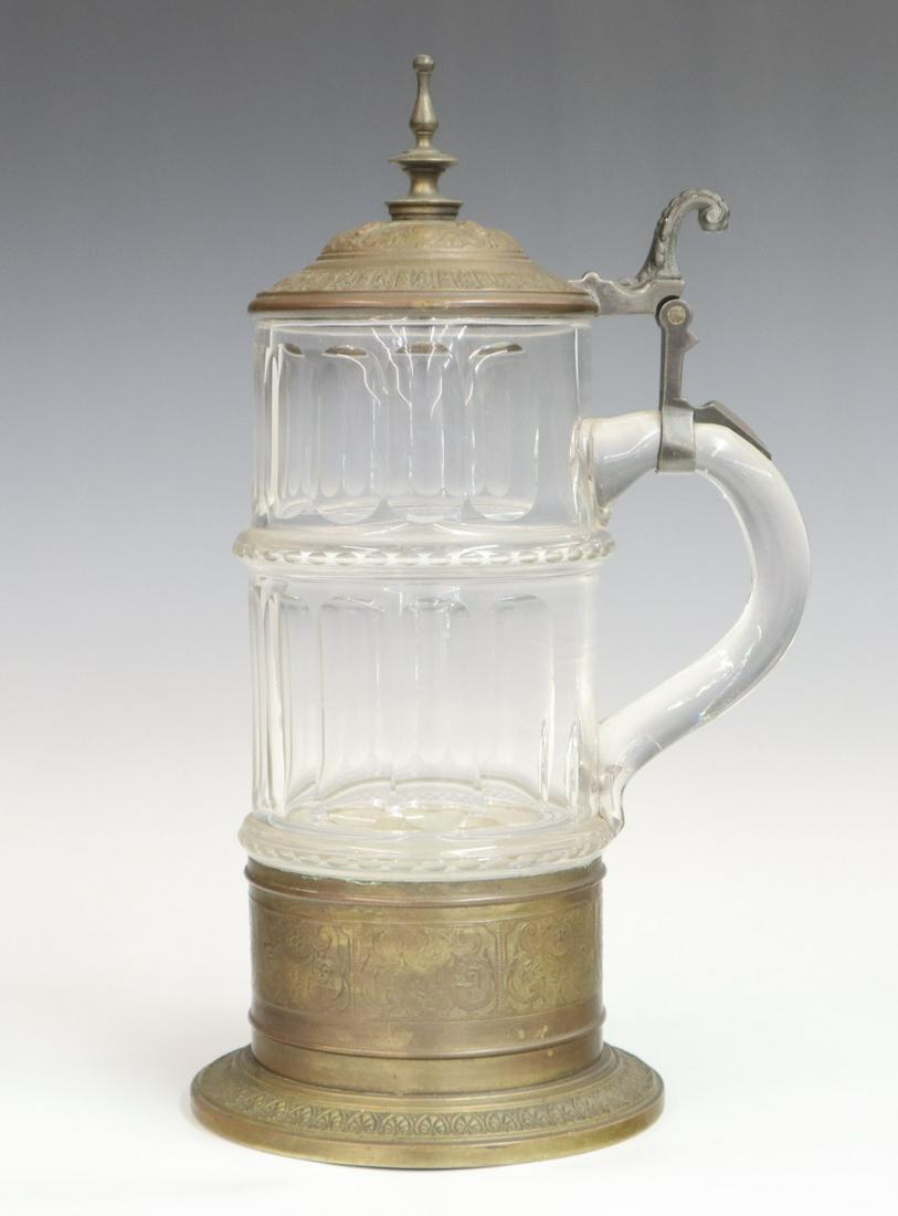 Glass and Pewter Stein: A 20th century pressed glass and pewter stein, embossed garland design in metalwork. Impressed "WMF M". Some wear overall. 13 1/2" high. ESTIMATE $100-200