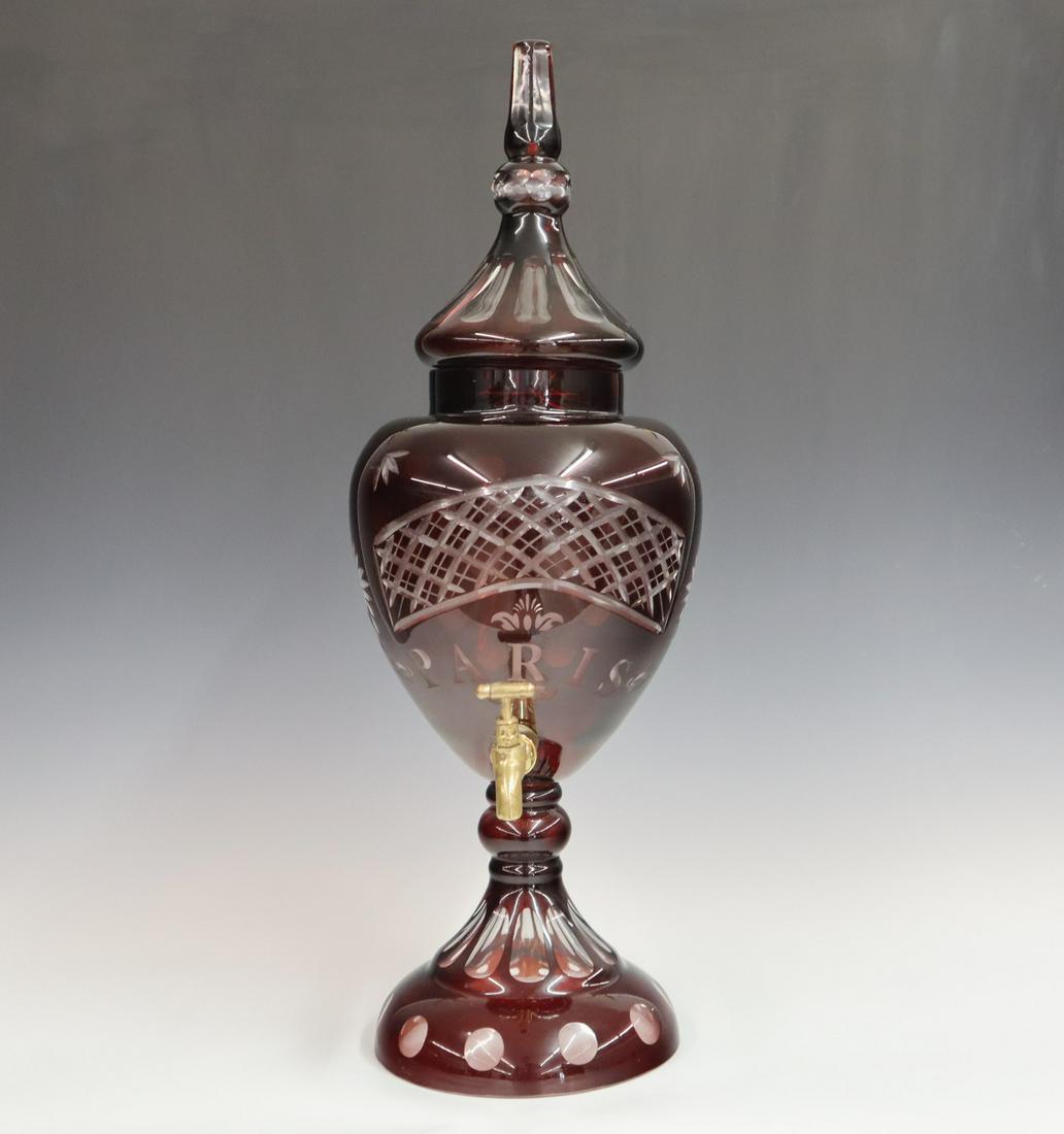 Replica Cranberry Liquor Dispenser: Replica cranberry cut to clear lidded liquor dispenser, marked "Paris" over brass spout. Very minor wear. 25 1/2" high. ESTIMATE $100-200