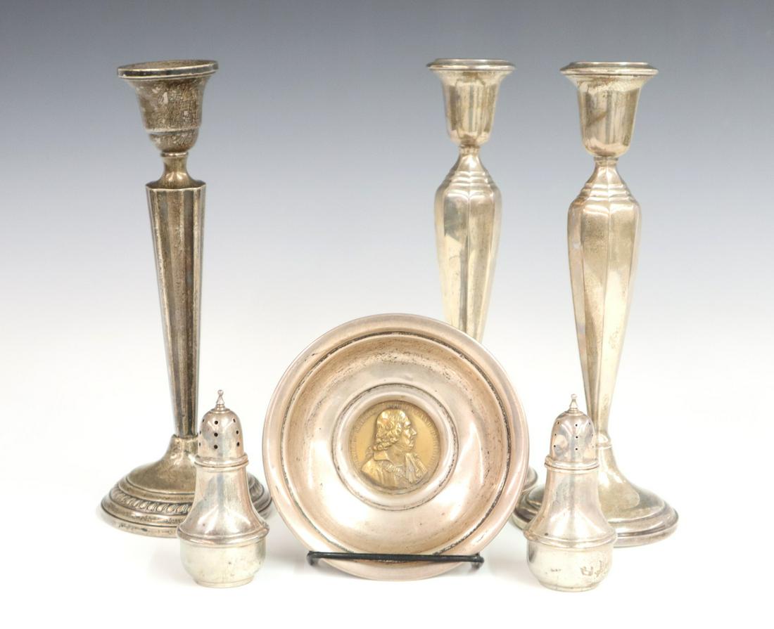 6 Sterling Silver Items: Six mid 20th century sterling silver, including 3 weighted candlesticks, a pair of salt and pepper shakers and a bowl with a bronze coin in base. Some wear and denting, one candlestick is slightly ben