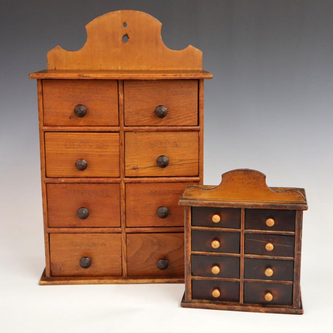 2 Hanging Spice Cabinets: Two turn of the century eight drawer wall hanging spice cabinets. The larger cabinet has been refinished and both pieces have minor wear. Up to 16 1/2" high. ESTIMATE $100-200