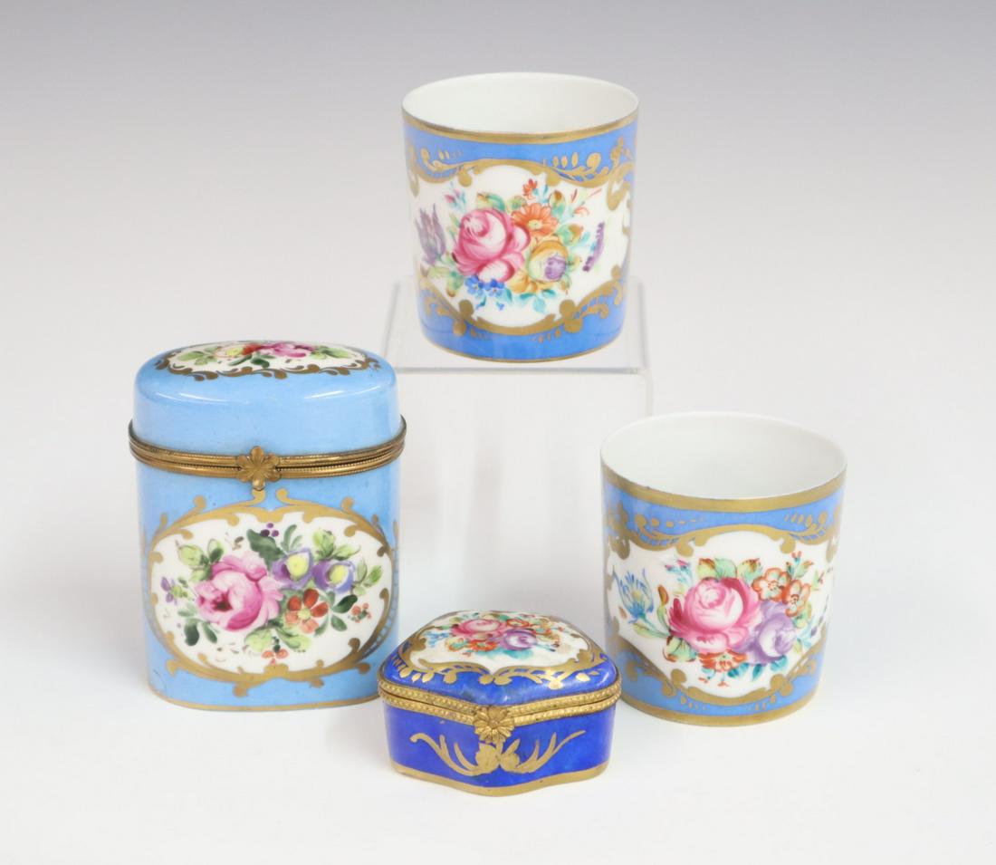 4 Limoges Porcelain Items: Four early 20th century Limoges porcelain items, including 2 covered boxes and two small canns; all with blue backgrounds surrounding floral decoration with gold accents. Painted marks include "Peiat 