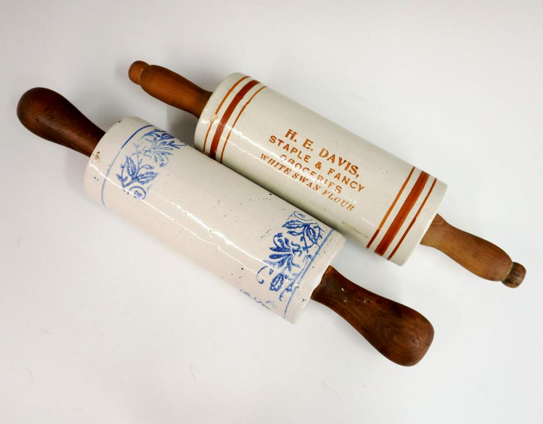 2 Stoneware Rolling Pins: Two 20th century decorated stoneware rolling pins with wood handles, one advertising pin for "H.E. Davis Groceries". Minor wear to handles. 14 1/2" - 15" long.