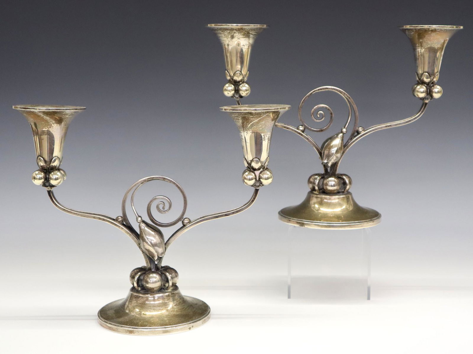 Sterling Candelabra: A pair of mid 20th century Sterling Silver two branch candelabra. Designed by Alphonse LaPaglia for International. LaPaglia manufactured Sterling items in his New Jersey studio for Georg Jensen USA du