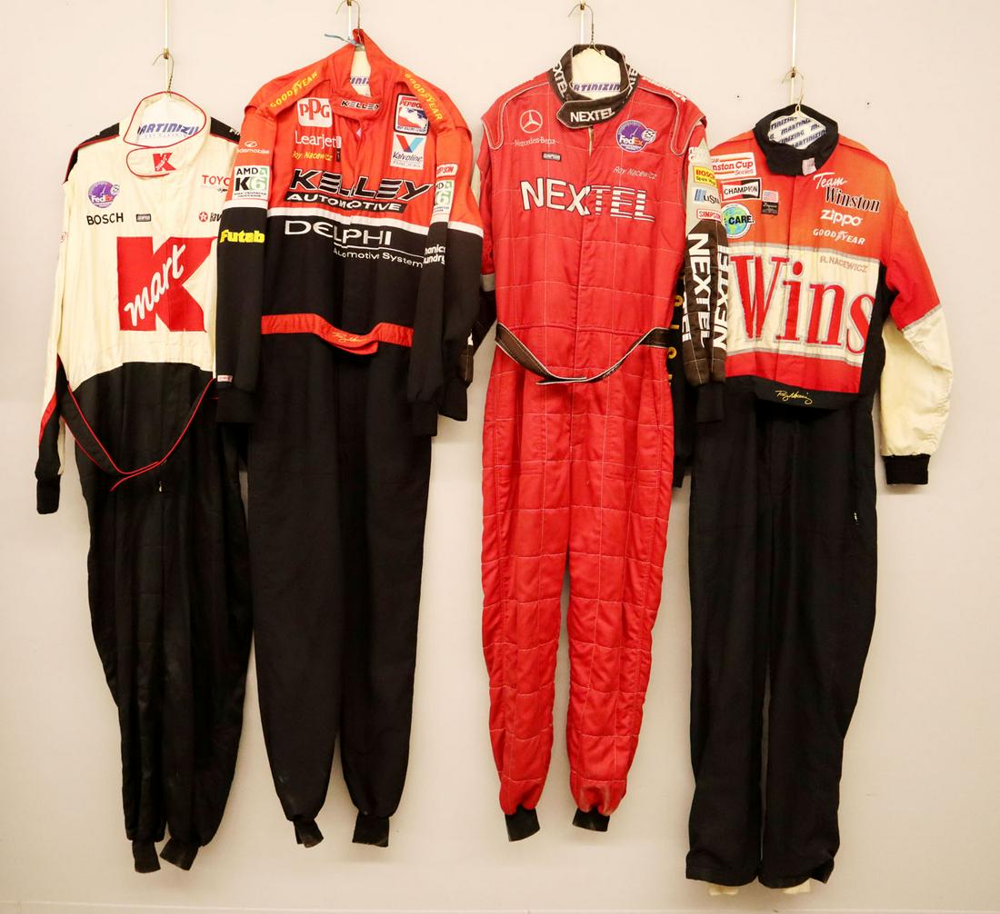 4 Simpson Racing Suits: Four Simpson racing suits. All one piece suits and race worn with various sponsor logos. General wear and fading. Size Large and Extra Large. ESTIMATE $100-200 The Winston and Kelly suits have "Roy Na