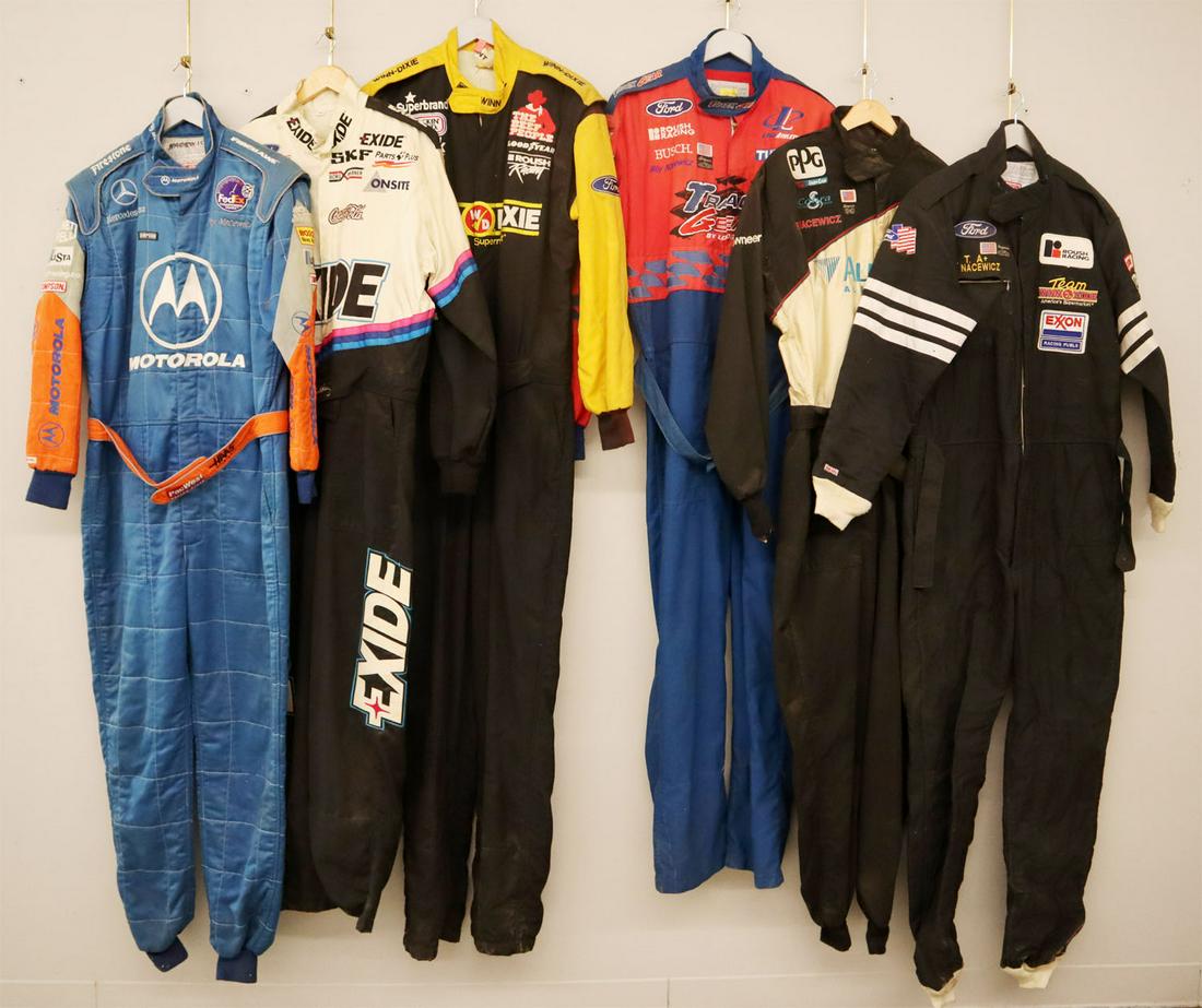 6 Racing Suits: Six racing suits. All one piece suits and race worn with various sponsor logos. General wear and fading. Size Large and Extra Large. ESTIMATE $100-200