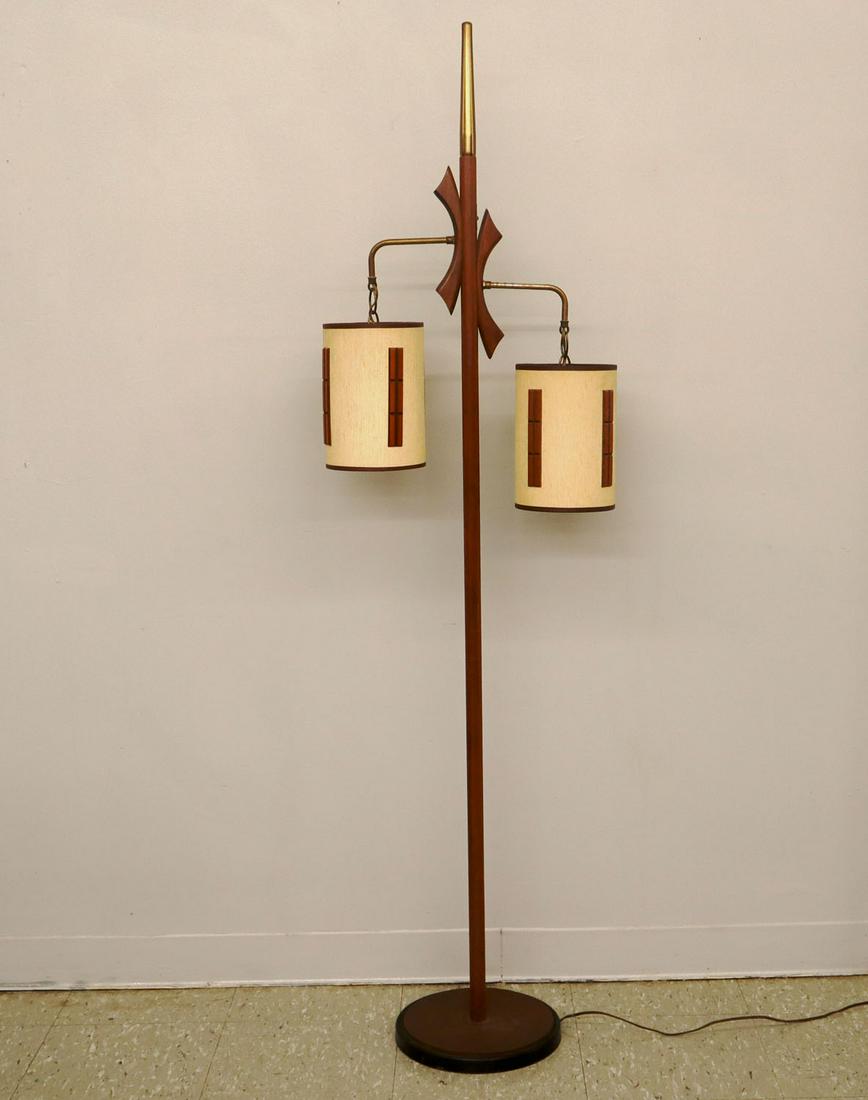 Midcentury 2 Light Floor Lamp: A mid-20th century two light floor lamp. Walnut with brass ornamentation, original fabric shade with wooden accents. Some tarnish to brass work, minor staining to shade. 65 1/2" high. ESTIMATE $100-20