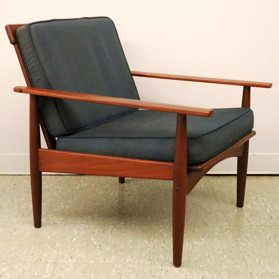 Komfort Armchair: A mid-20th century teak armchair by Komfort, Denmark. With paddle style arms. Original finish with very minor wear, some fading to fabric cushions. 28" high. ESTIMATE $200-400