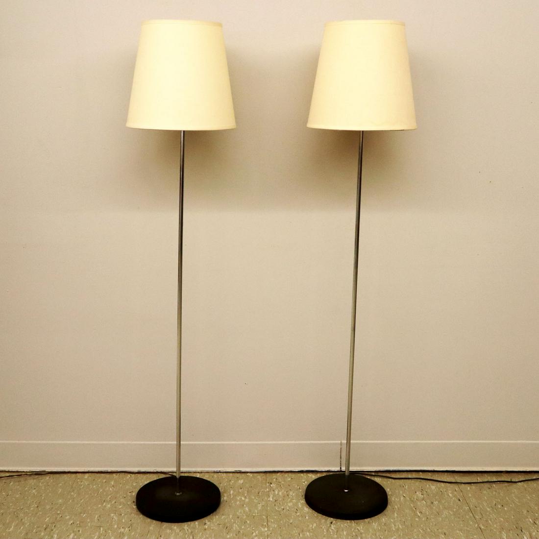 Pair of Chrome & Enamel Floor Lamps: A pair of mid-20th century chrome & enamel floor lamps. Bases show minor wear and slightly differ in edges. Replaced fabric shades. 55" high. ESTIMATE $100-200