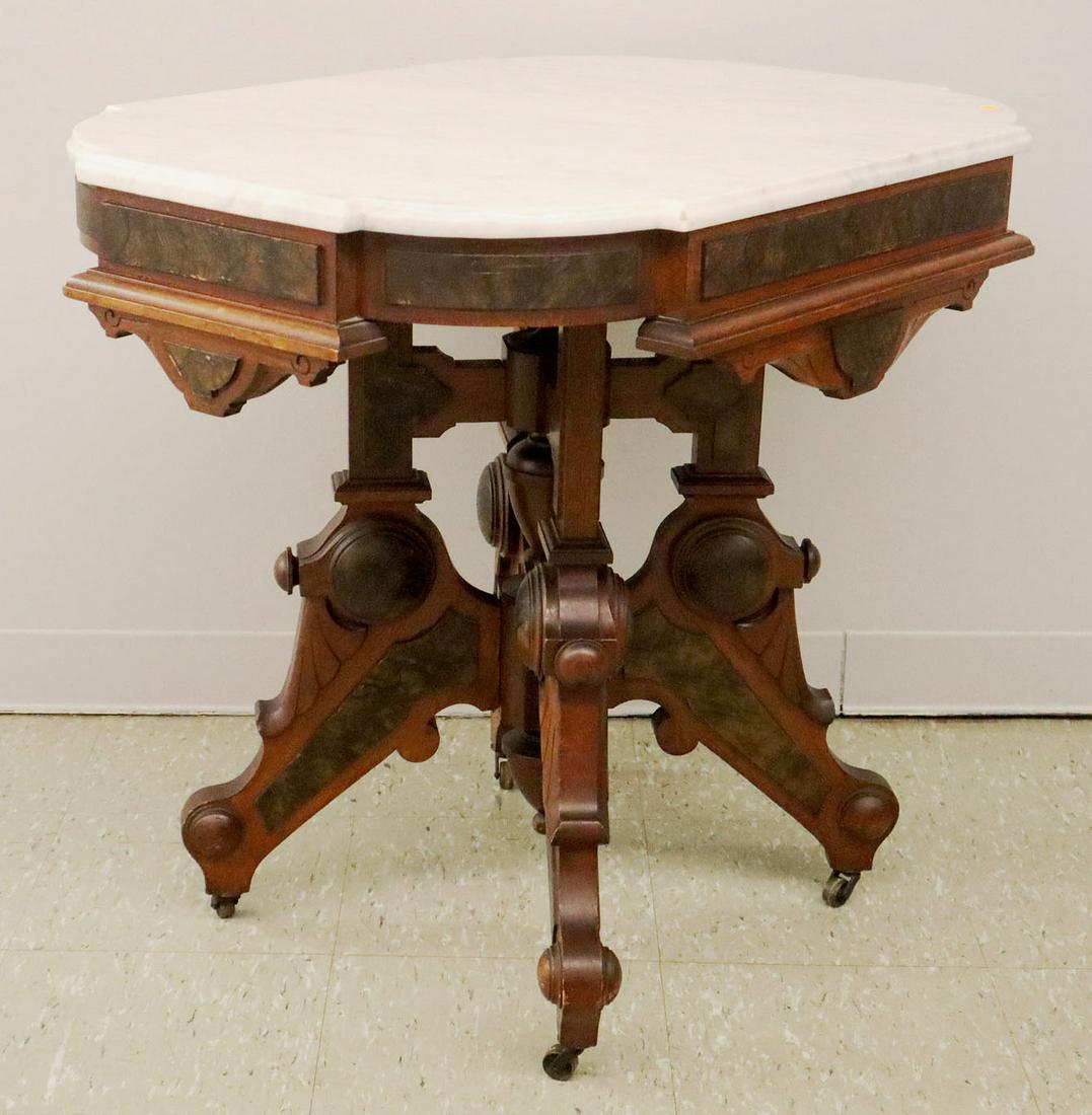 American Victorian Walnut Marble Top Parlor Table: A mid 19th century American Victorian walnut marble top parlor table. Having burl walnut panels and rosettes with a Renaissance Revival style shaped white marble top. Minor wear at leg corners, minor 