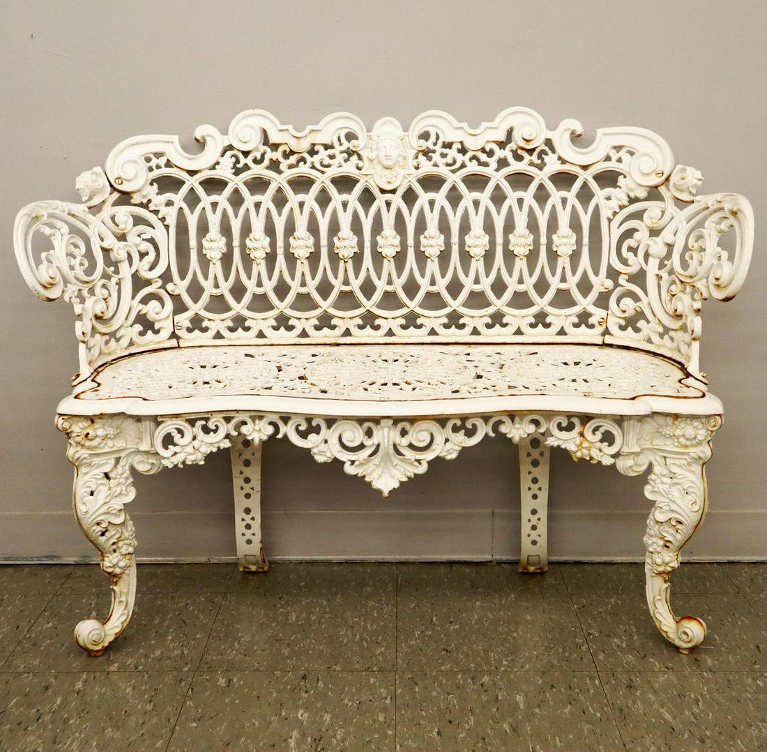 Cast Iron Garden Bench: A 1920s cast iron garden bench. Cast seat with cast Minerva on top rail. Older refinish with minor surface rust. 44 1/2 x 16 1/2 x 33" high. ESTIMATE $200-400