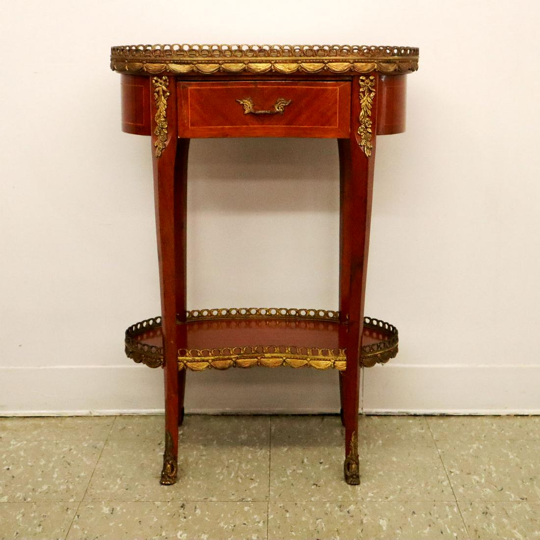 French Marble Top Side Table: A 1920s French marble top side table. Kidney shaped with bronze mounts. Minor scratch to marble and small scratches to finish, mounts slightly tarnished. 20 1/2 x 14 x 28 1/2" high. ESTIMATE $100-200