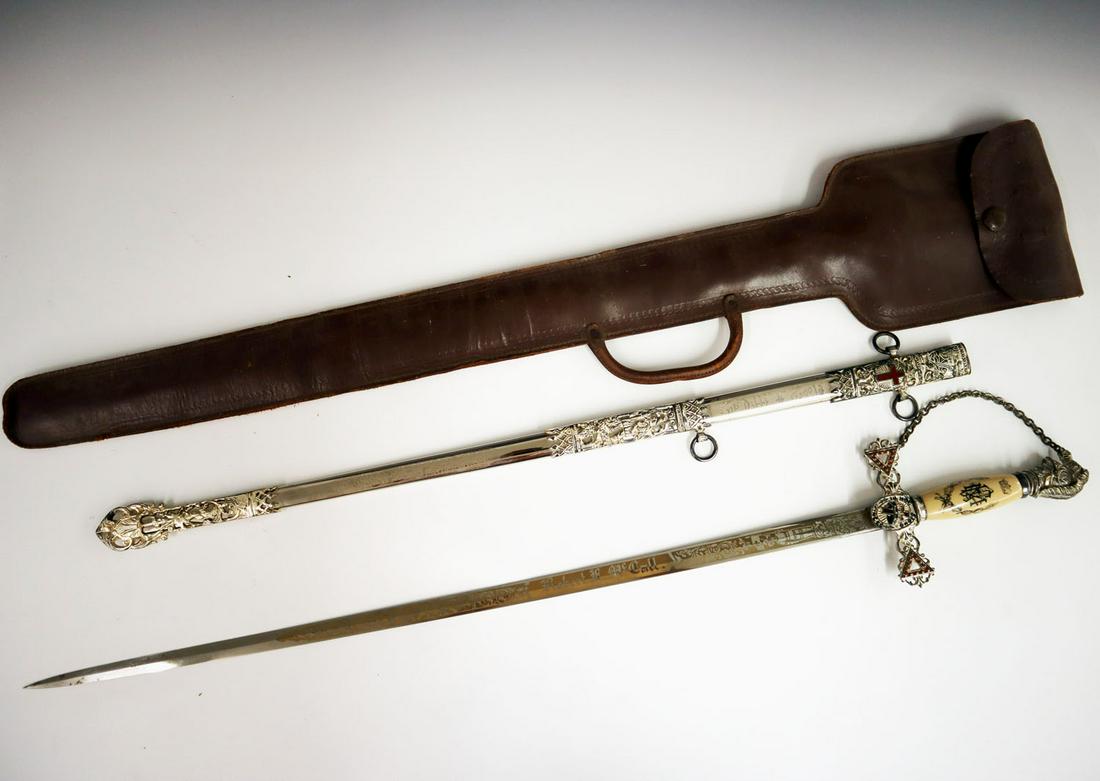Knights of Columbus Dress Sword: A 20th century Knights of Columbus fraternal dress sword. Nickle plated with ivorine handle, the blade engraved "Robert A. McCall". Includes leather case. Wear to handle and sheath mountings. 38" long