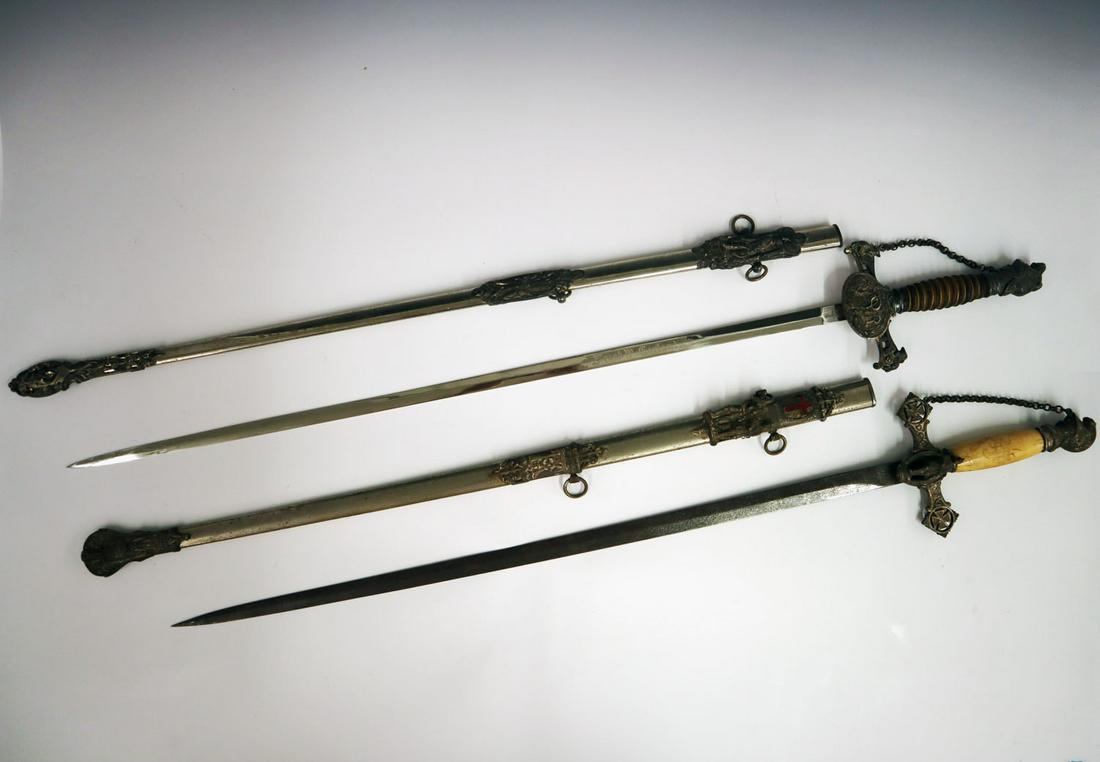 2 Knights of Columbus Dress Swords: Two 20th century Knights of Columbus fraternal dress swords. Both nickel plated, includes one with ivorine handle and plain blade, the other with a leather wrapped handle and engraved blade. Plating w