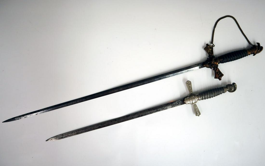 2 Knights of Columbus Swords: Two 20th century Knights of Columbus swords. One with leather wrapped handle, blade engraved "Roy Finish", the other a short sword with metal handle, blade engraved "May W. Elliot Chapter". Both have 