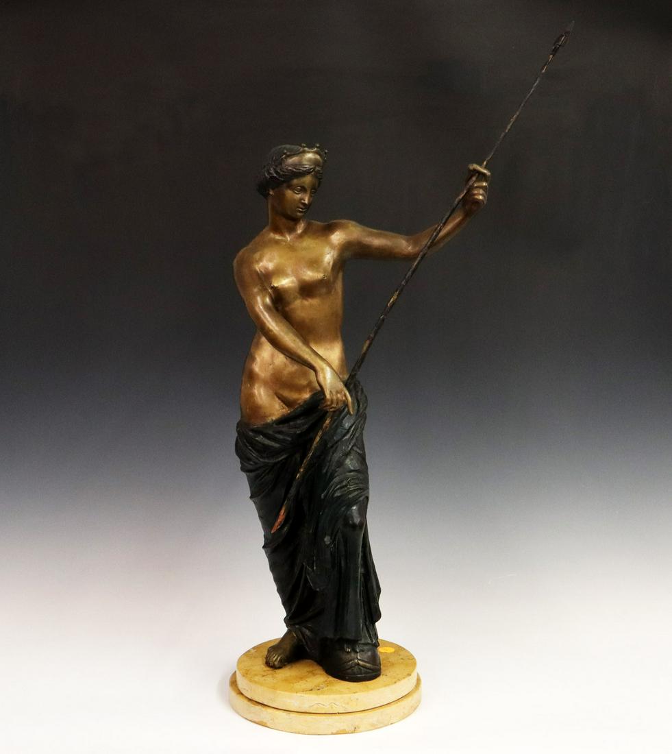 Bronze Sculpture: A Mid 20th Century Bronze Sculpture. Cast bronze figure depicting "Diana the Huntress" shown wearing a crown atop her head and a garment draped about her waist, as she holds a spear in one hand and re