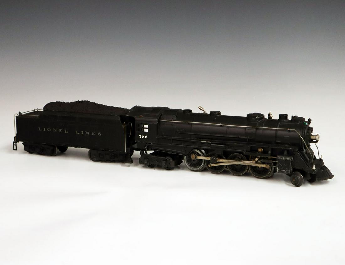 Lionel Locomotive & Tender: A Post-War O-Gauge Lionel Locomotive & Tender. Includes a 726 locomotive and a 2426 W tender. Minor paint loss and light grime. 20 1/2" long. ESTIMATE $100-200