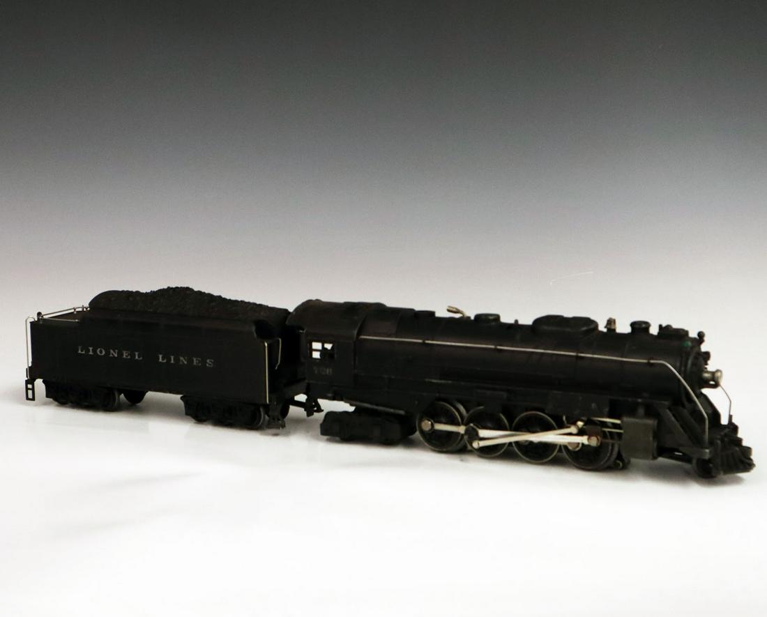 Lionel Locomotive & Tender: A Post-War O-Gauge Lionel Locomotive & Tender. Includes a 726 locomotive and a 2426 W tender. Minor paint loss and light grime. 20 1/2" long. ESTIMATE $100-200
