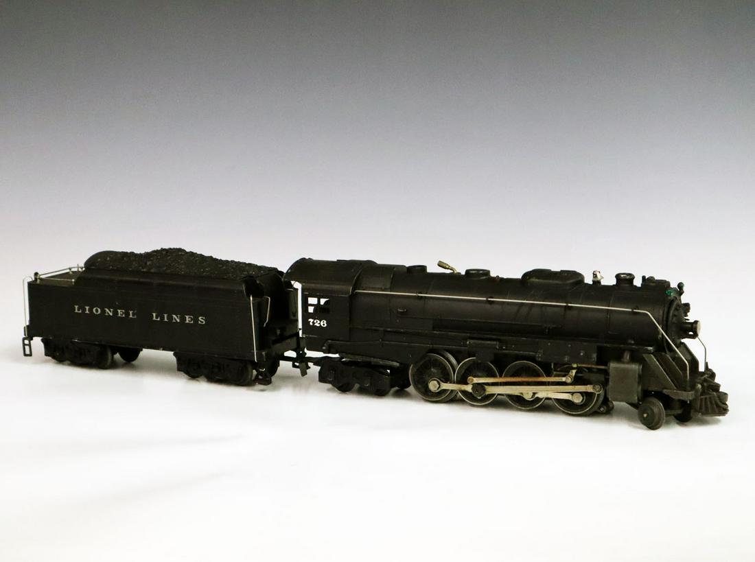 Lionel Locomotive & Tender: A Post-War O-Gauge Lionel Locomotive & Tender. Includes a 726 locomotive and a 2426 W tender. Minor paint loss and light grime. 20 1/2" long. ESTIMATE $100-200