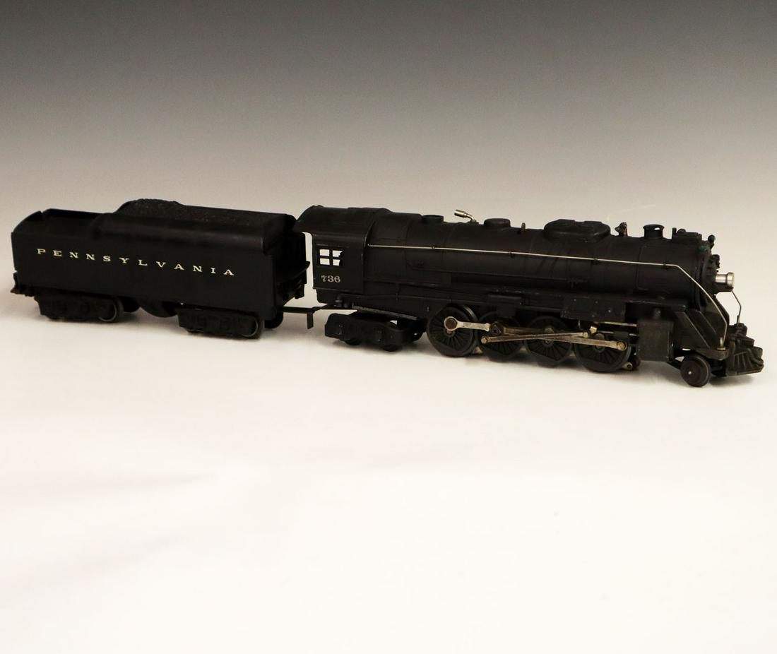 Lionel Locomotive & Tender: A Post-War O-Gauge Lionel Locomotive & Tender. Includes a 736 locomotive and a 2671 W tender. Minor paint loss and light grime. 21" long. ESTIMATE $100-200