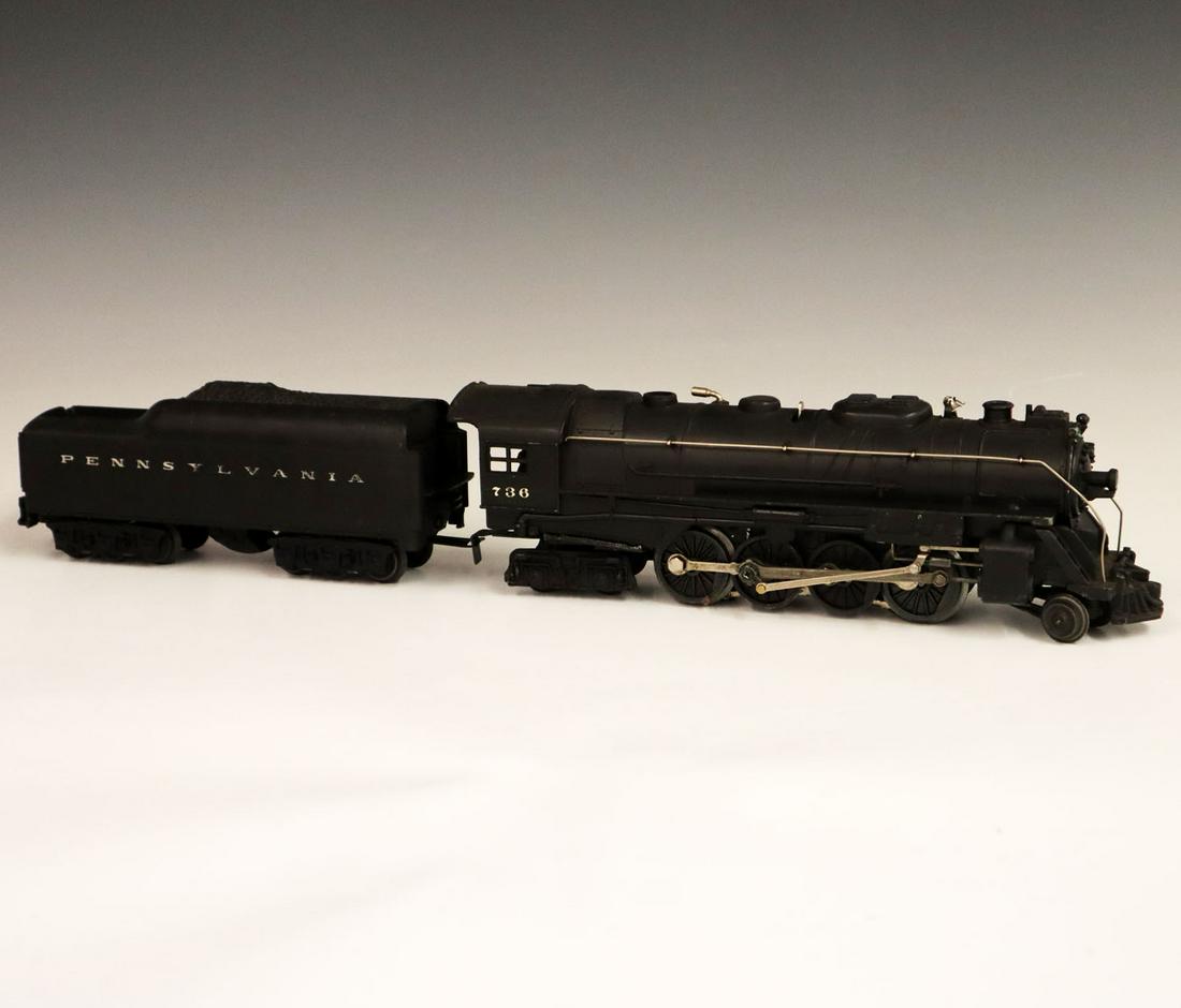 Lionel Locomotive & Tender: A Post-War O-Gauge Lionel Locomotive & Tender. Includes a 736 locomotive and a 2571 W tender. Minor paint loss and light grime. 21" long. ESTIMATE $100-200