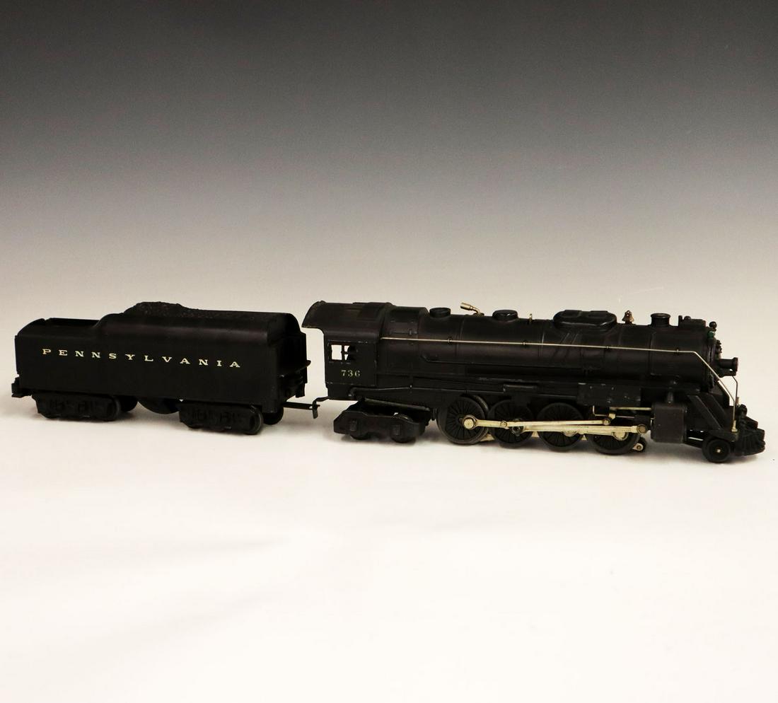Lionel Locomotive & Tender: A Post-War O-Gauge Lionel Locomotive & Tender. Includes a 736 locomotive and a 2671 W tender. Minor paint loss and light grime. 21" long. ESTIMATE $100-200