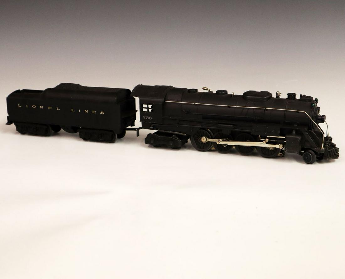 Lionel Locomotive & Tender: A Post-War O-Gauge Lionel Locomotive & Tender. Includes a 736 locomotive and a 2671 tender. Minor paint loss and light grime. 21" long. ESTIMATE $100-200