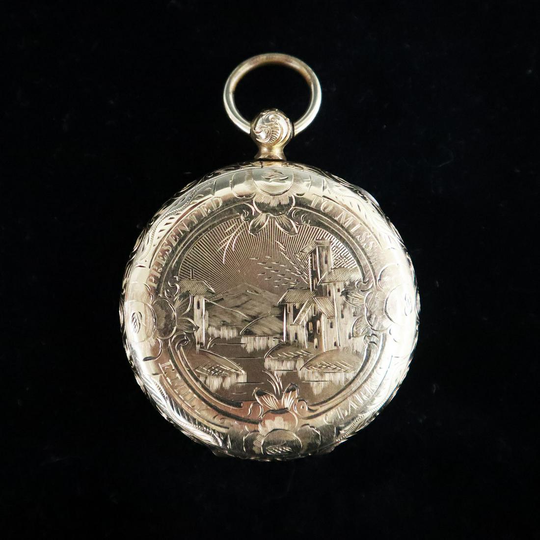 Gold Filled Locket: A 19th Century Gold Filled Locket. Large locket with engraving that reads "Presented to Miss Emily Clark" at the front and "By The Frank Street Choir" at the reverse. Holds four photos. Small (1/16") 