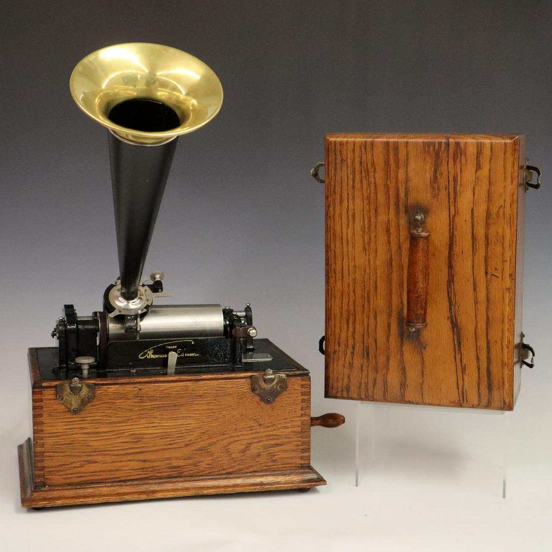 Edison "Suitcase" Phonograph: A Turn of the Century Edison Standard "Suitcase" Model Phonograph. Having a square oak case with finger joint corners and 4 clips to secure the top and a painted black horn. Serial #522331. Running wh