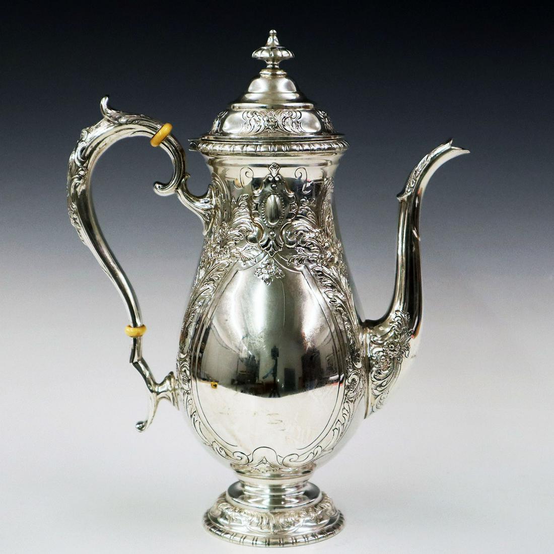 Towle "King Richard" Sterling Coffee Pot: A Turn of the Century Towle "King Richard" Sterling Silver Coffee Pot. With repousse and chased decoration, all resting on a round foot. Slight surface marks, 1/2" long dent at one side. 11 3/4" high.