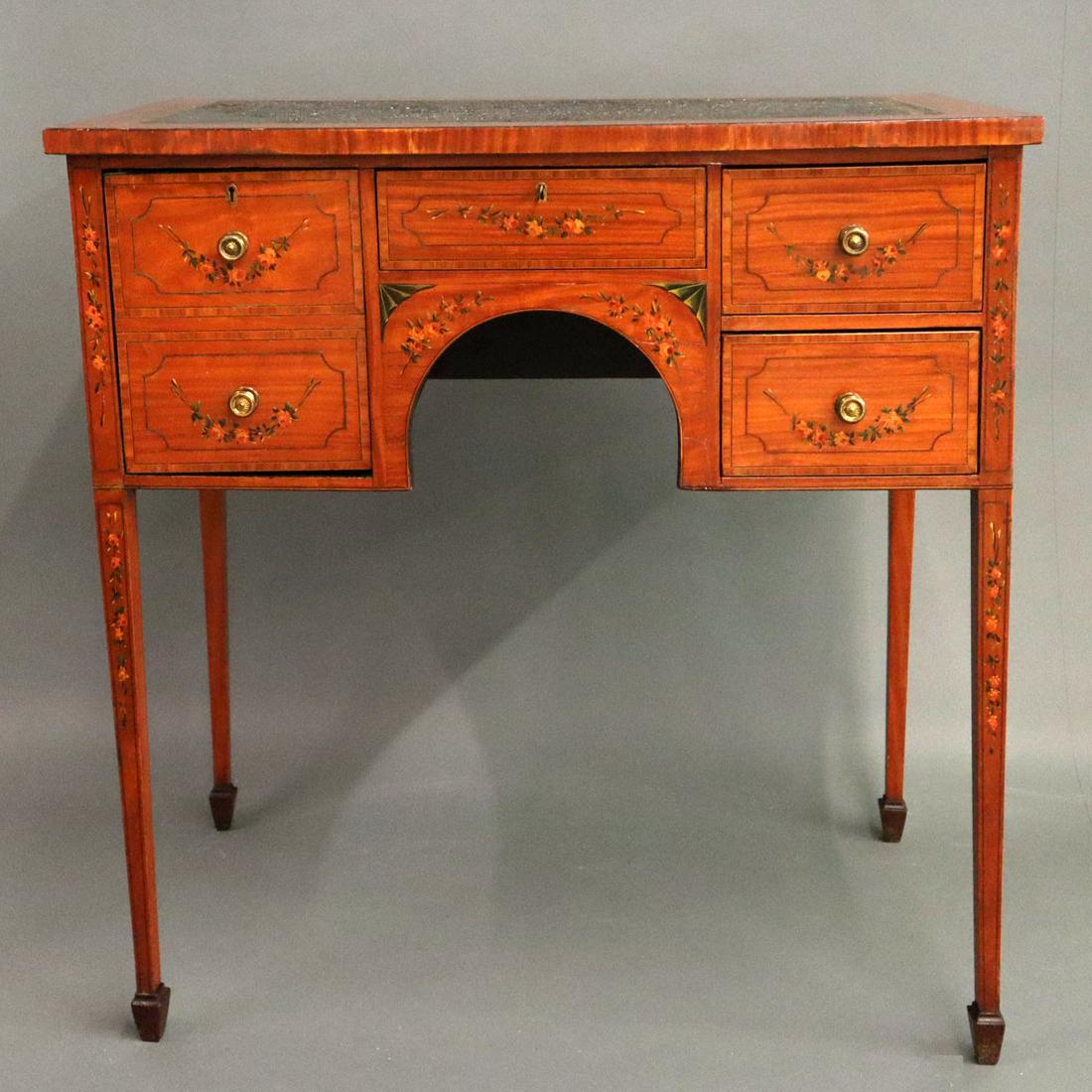English Satinwood Lowboy: A Late 19th to Early 20th Century English Lowboy. Edwardian era satinwood lowboy with hand painted decoration of urns and floral garlands and an leather inlaid top above a small center drawer and a se