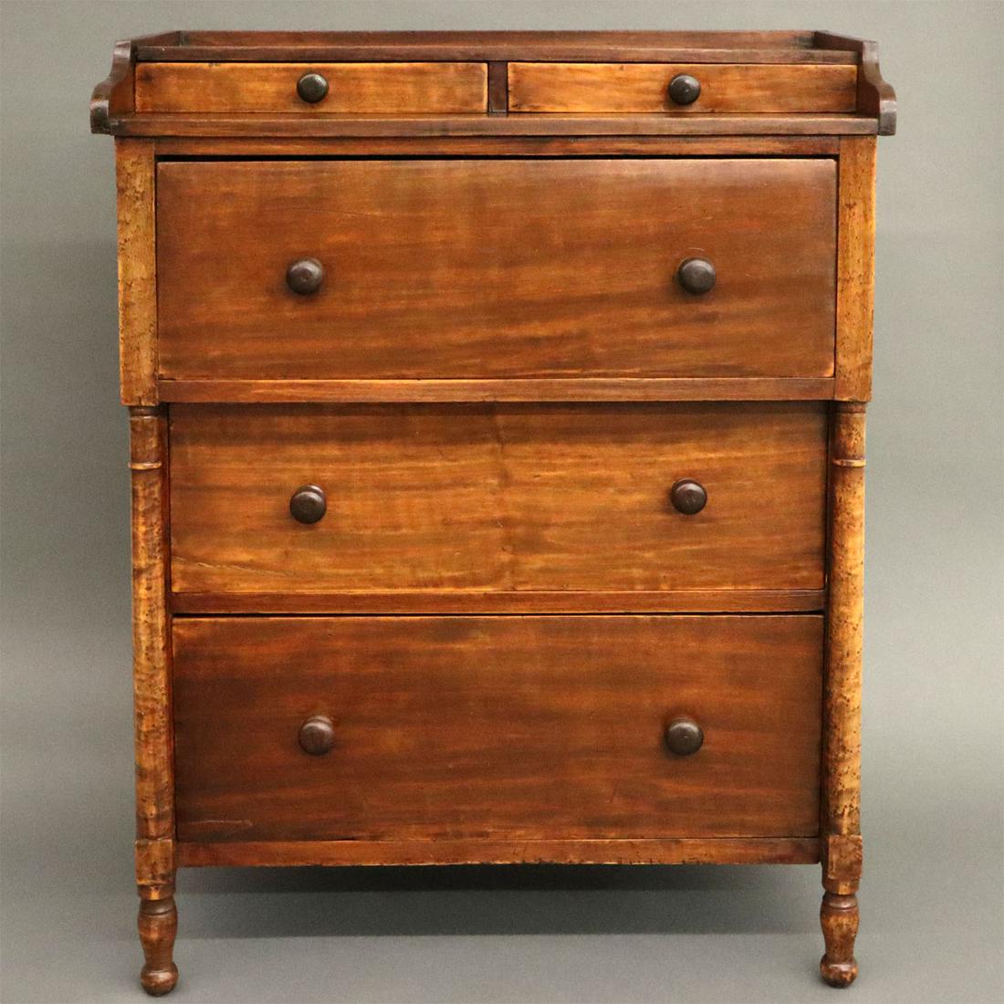Child's Chest: A Mid-19th Century American Child's Chest. Cherry and maple construction with two small drawers over three large drawers, decorated with turned Birdseye Maple columns. Needs drawer stops, minor wear t